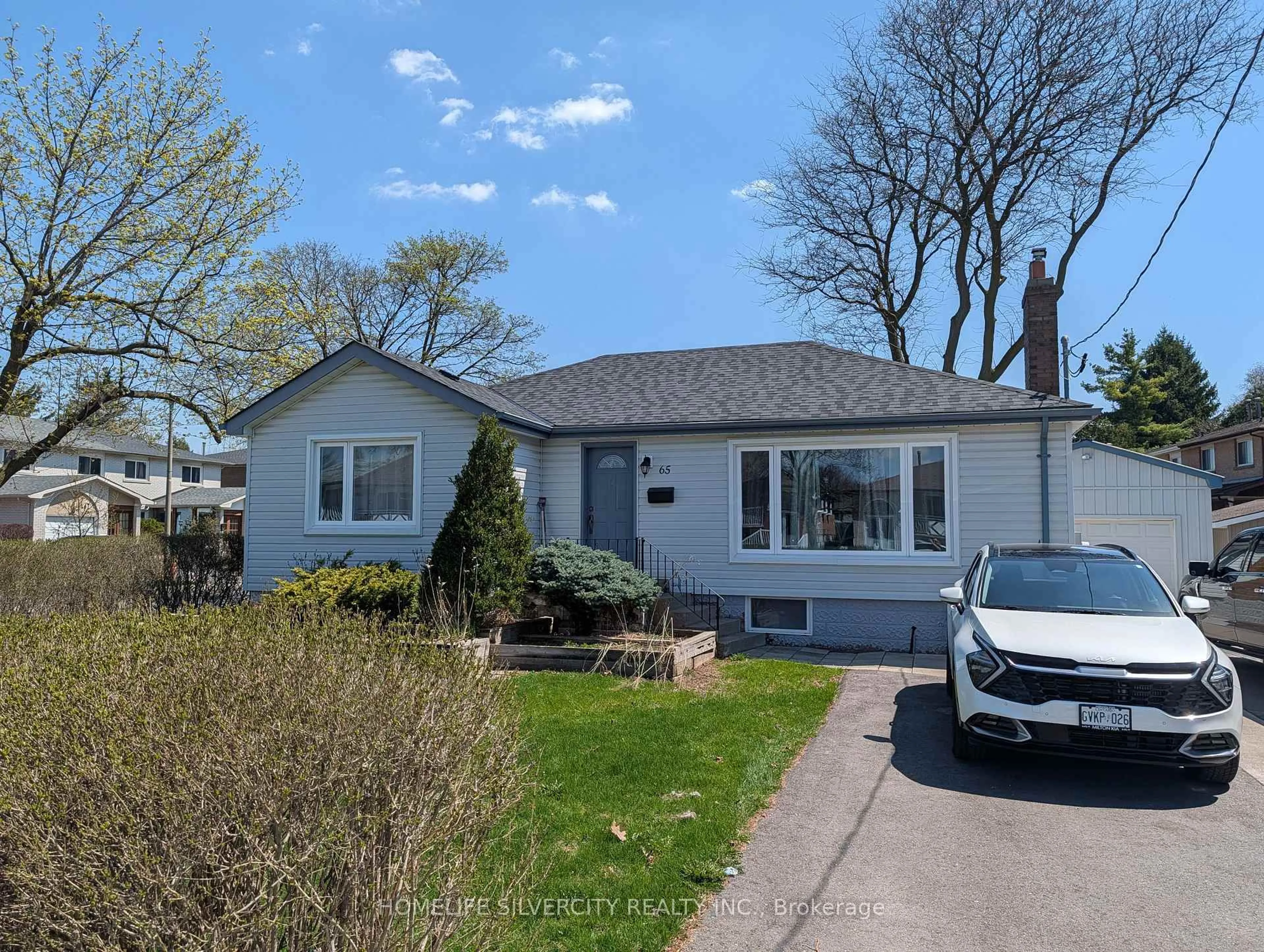 Home with vinyl exterior material, street for 65 English St, Brampton Ontario L6X 1L5