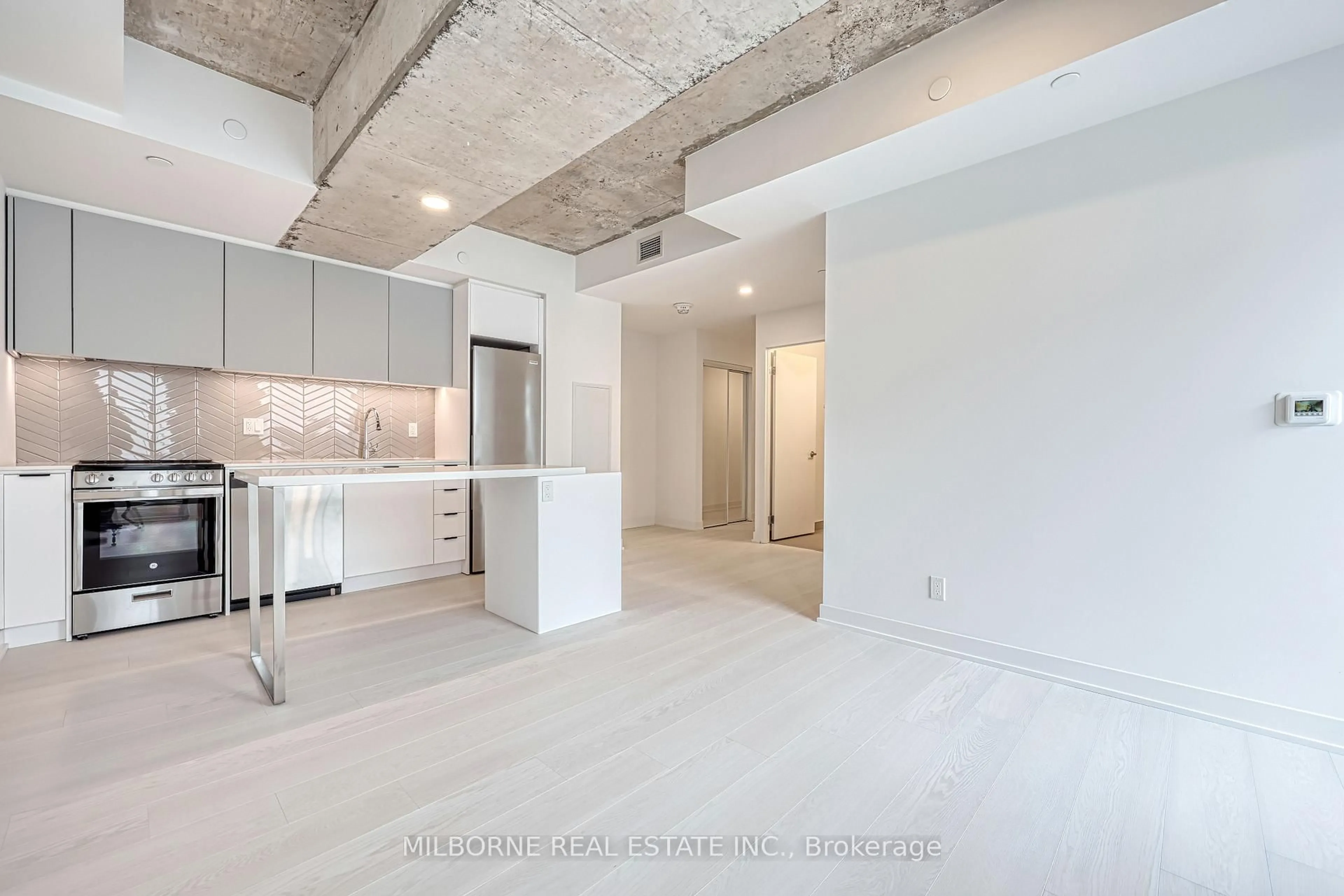 Open concept kitchen, cement floor for 57 Brock Ave #104, Toronto Ontario M3H 3N2