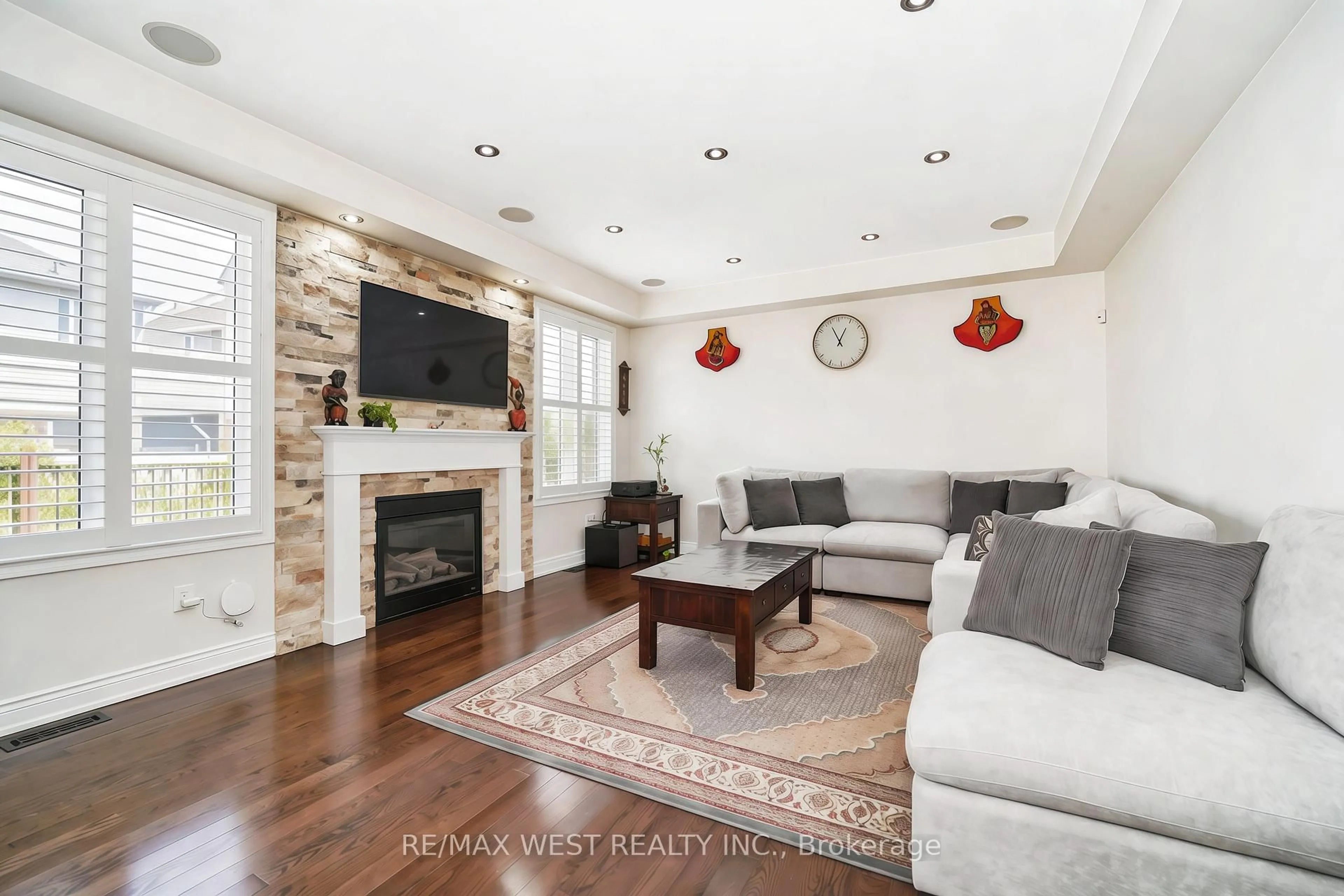 Living room with furniture, wood/laminate floor for 7 Aldersgate Dr, Brampton Ontario L7A 4A9