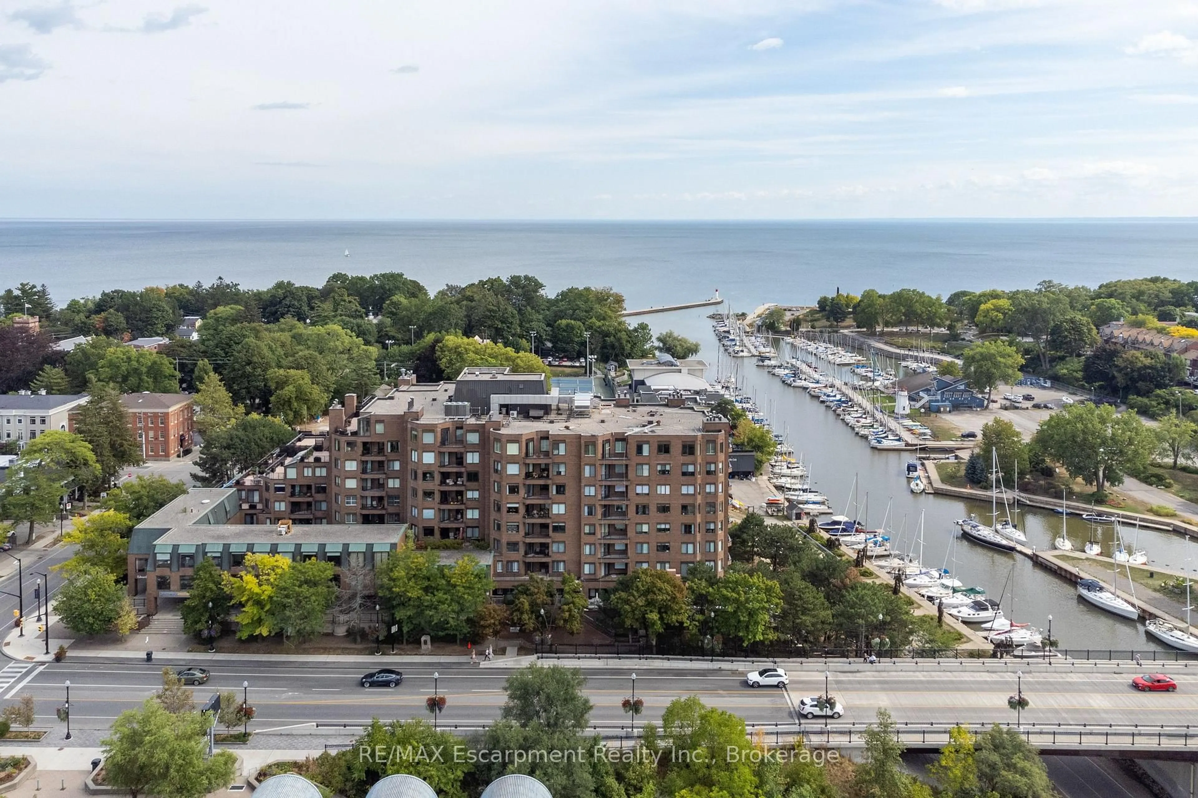 A pic from outside/outdoor area/front of a property/back of a property/a pic from drone, water/lake/river/ocean view for 100 Lakeshore Rd #303, Oakville Ontario L6J 6M9