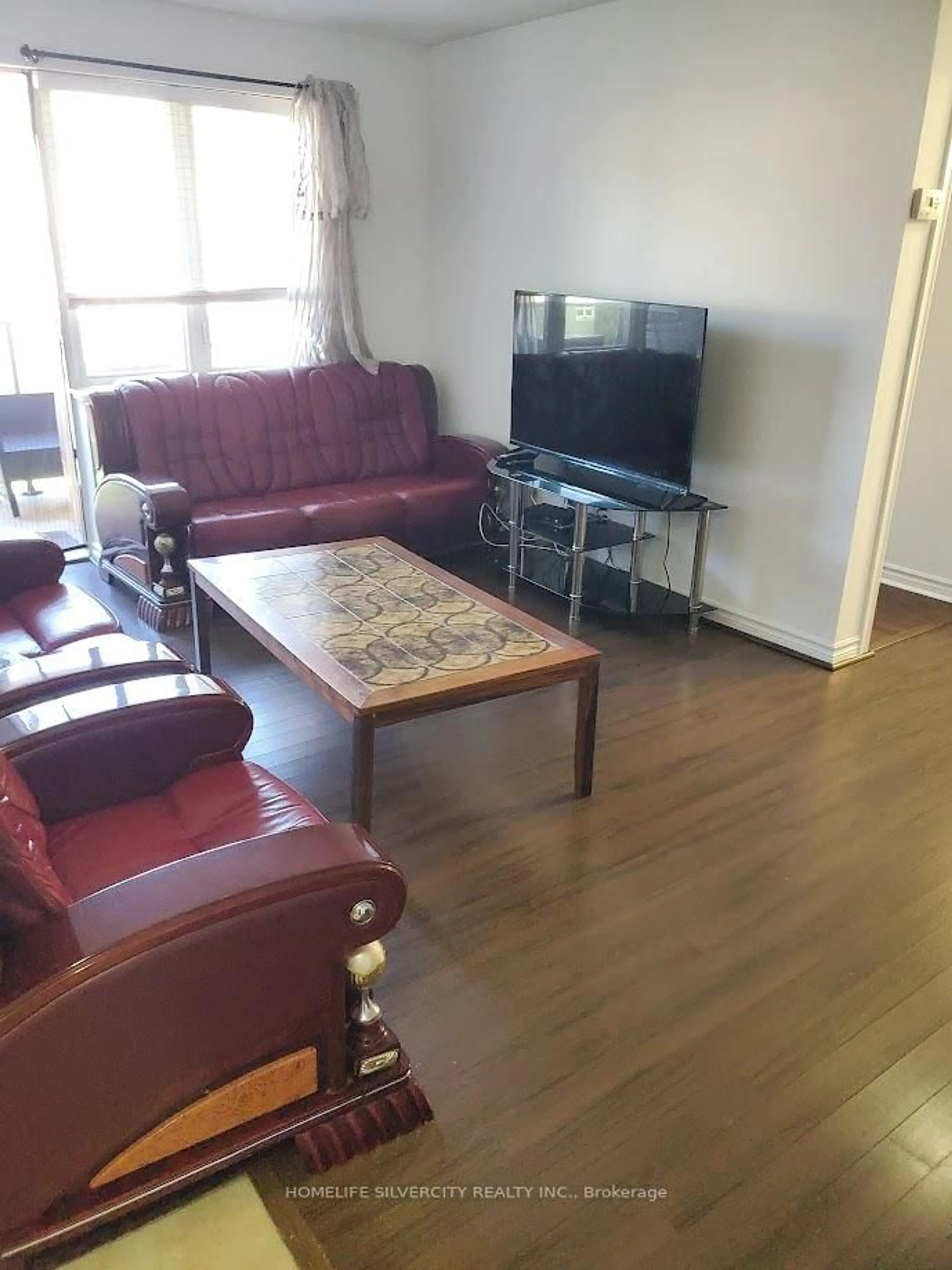 Living room with furniture, wood/laminate floor for 7 Dayspring Circ #303, Brampton Ontario L6P 1B7