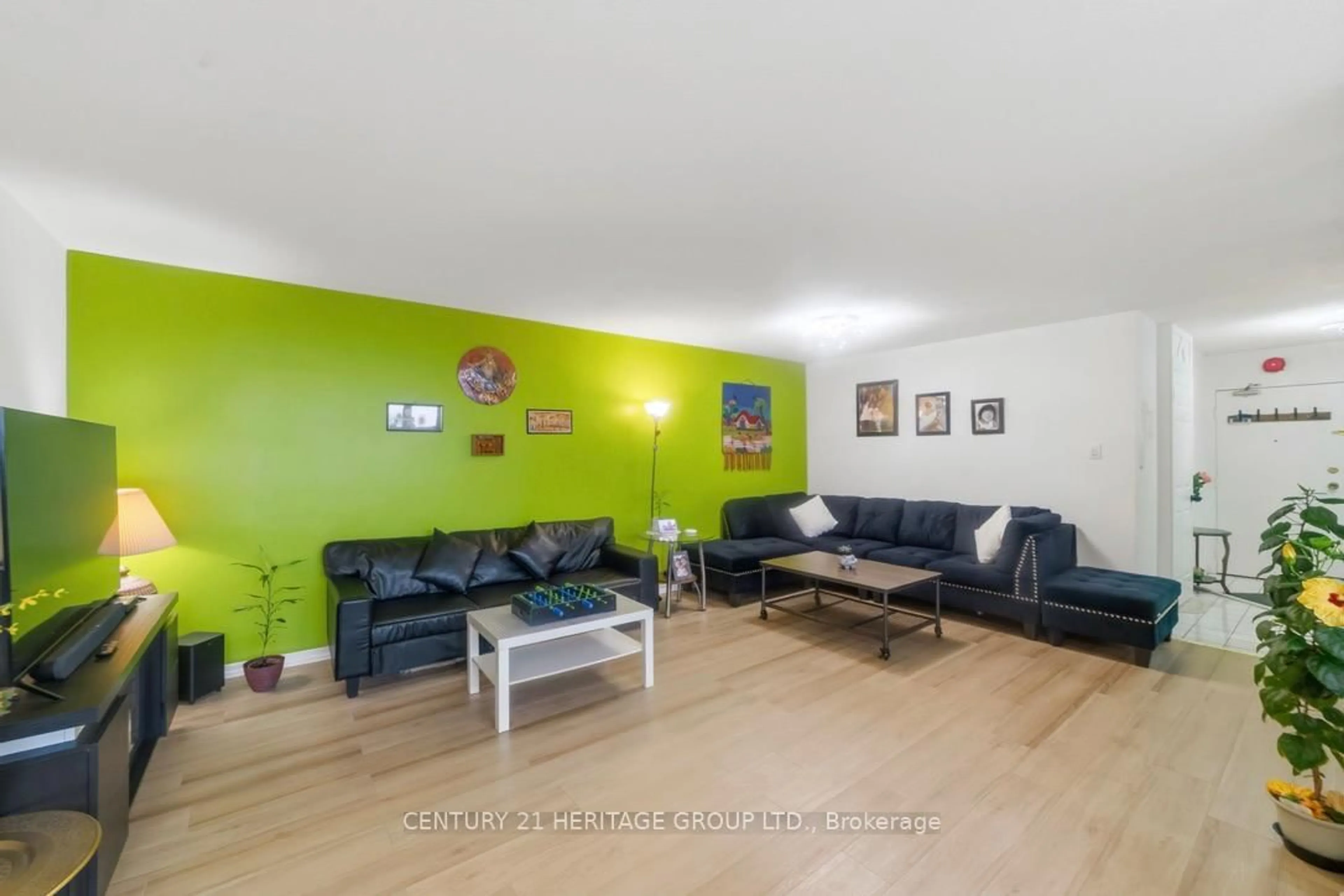 Living room with furniture, wood/laminate floor for 2323 Confederation Pkwy #1408, Mississauga Ontario L5B 1R6