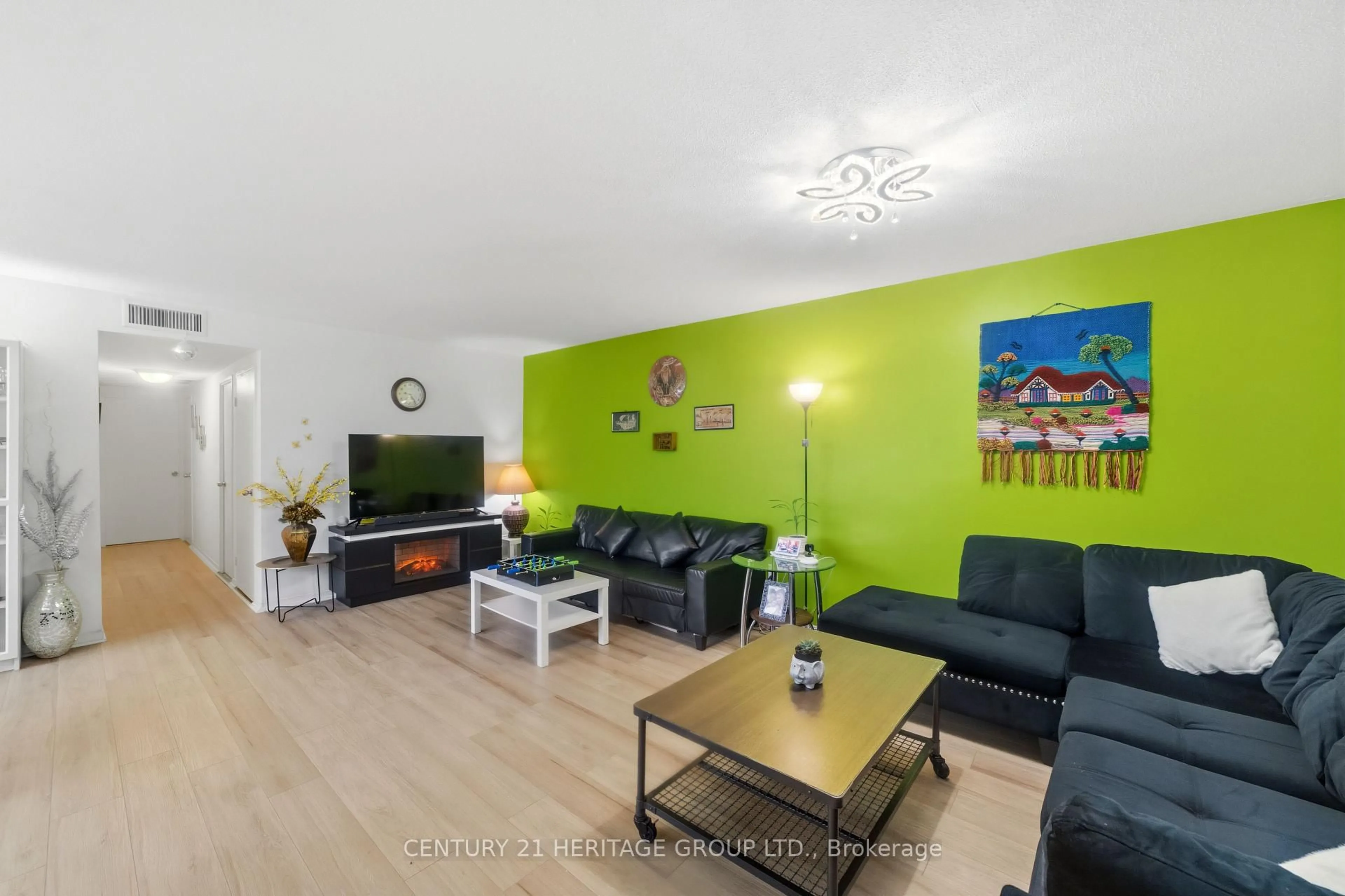 Living room with furniture, wood/laminate floor for 2323 Confederation Pkwy #1408, Mississauga Ontario L5B 1R6