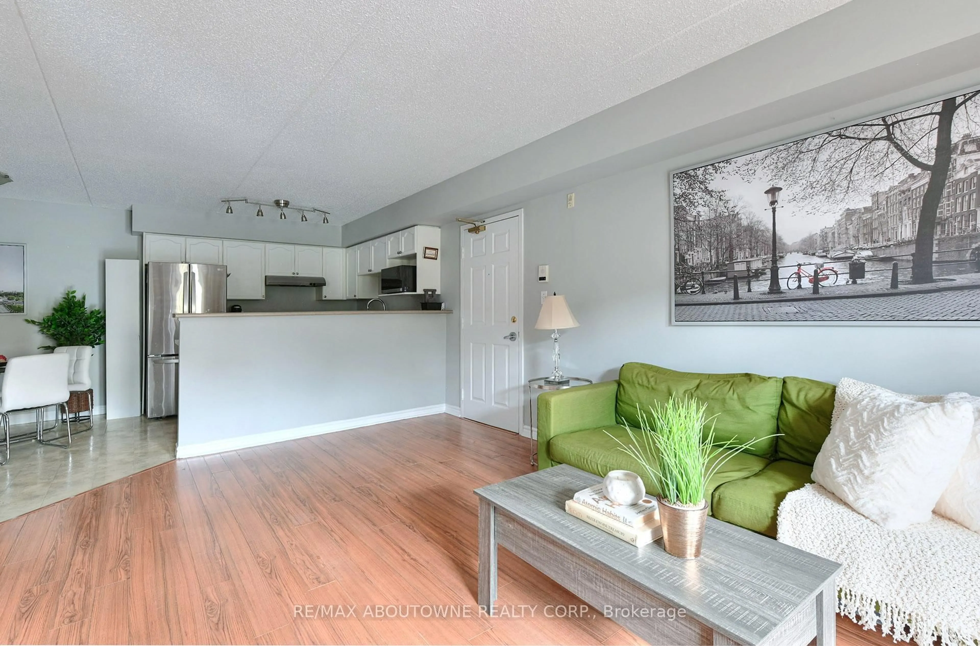 Living room with furniture, wood/laminate floor for 1470 Bishops Gate #104, Oakville Ontario L6M 4N2