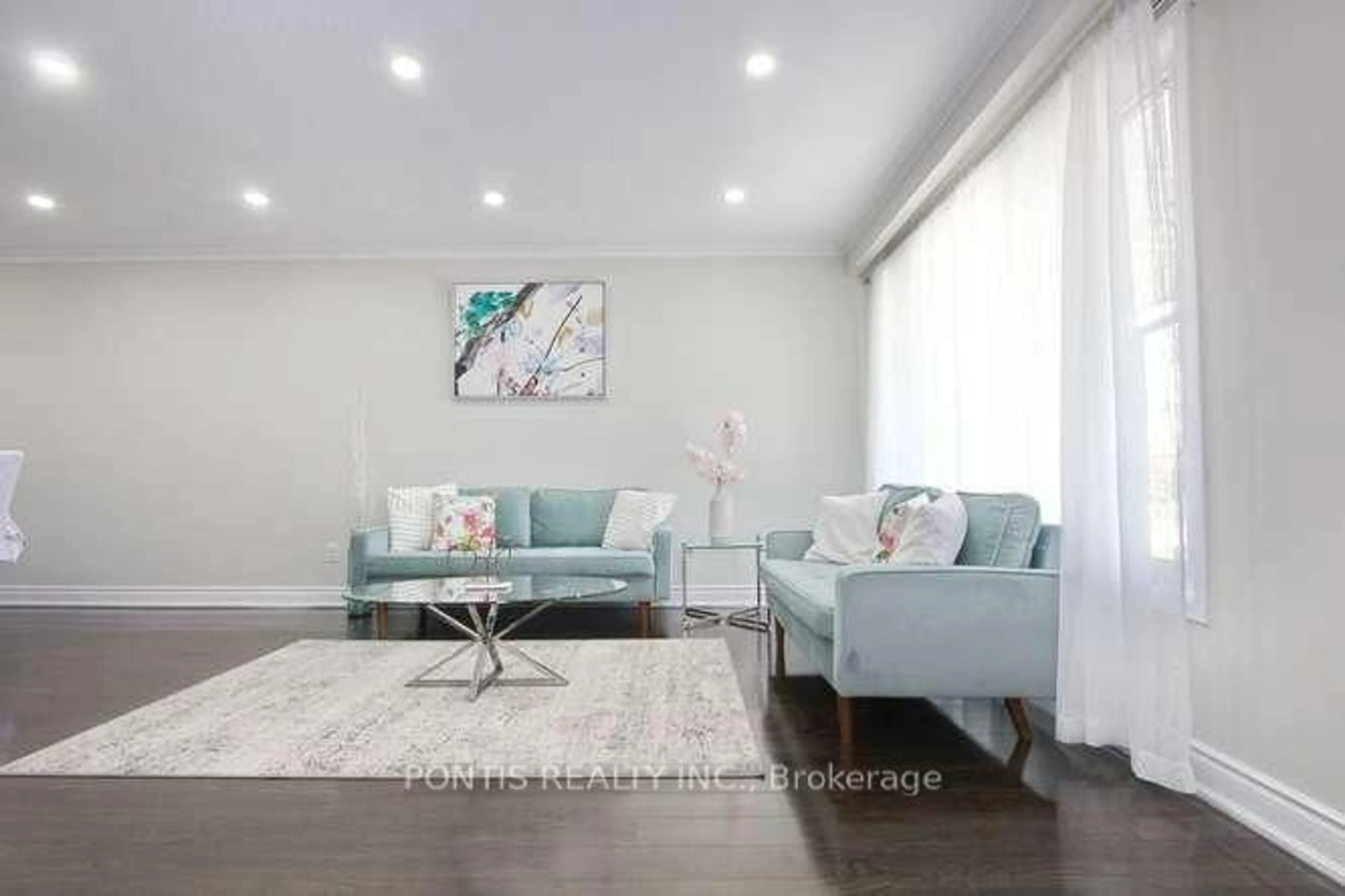 Living room with furniture, wood/laminate floor for 7292 Sills Rd, Mississauga Ontario L4T 2K1