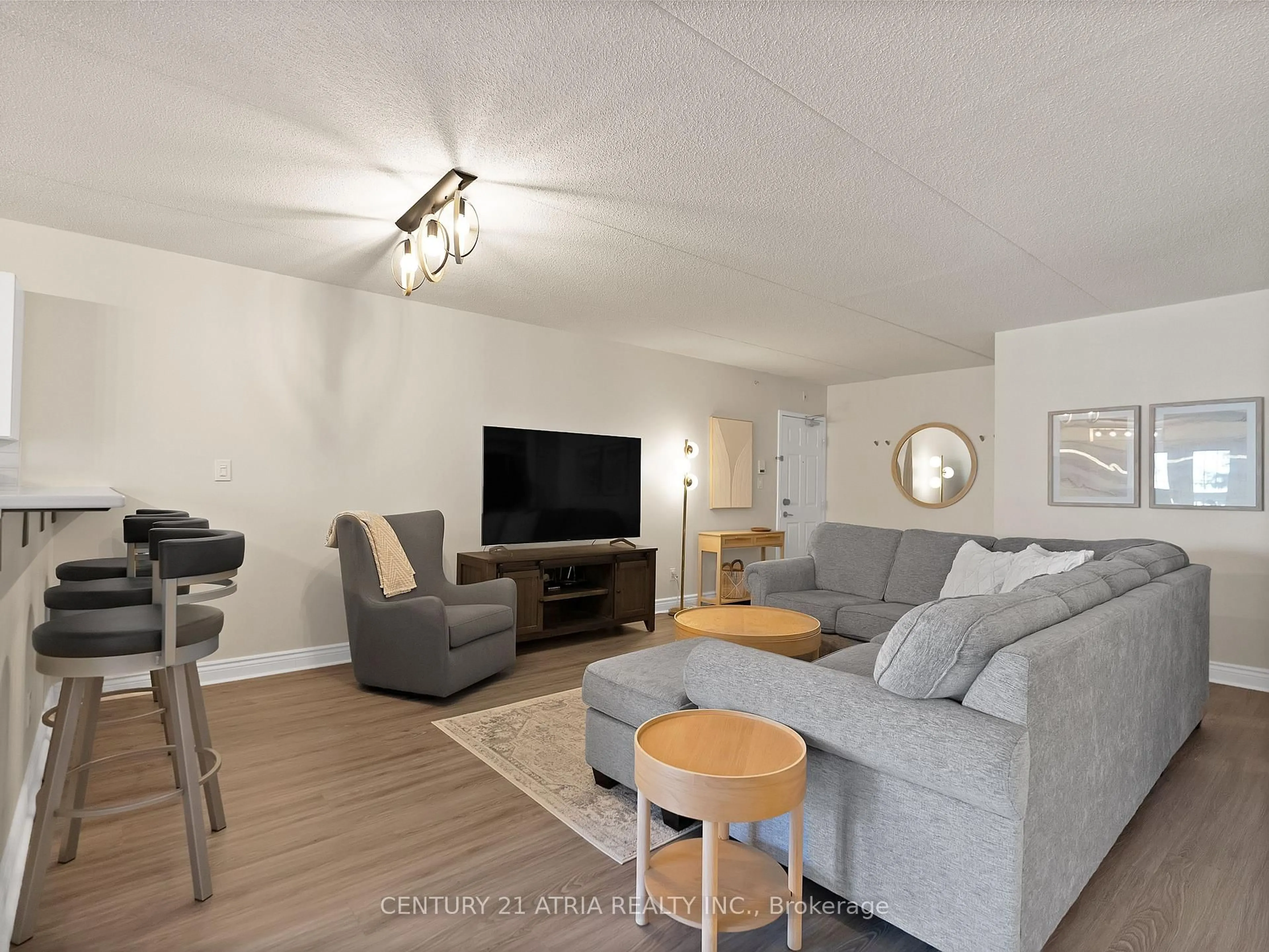 Living room with furniture, wood/laminate floor for 4015 Kilmer Dr #305, Burlington Ontario L7M 4M4