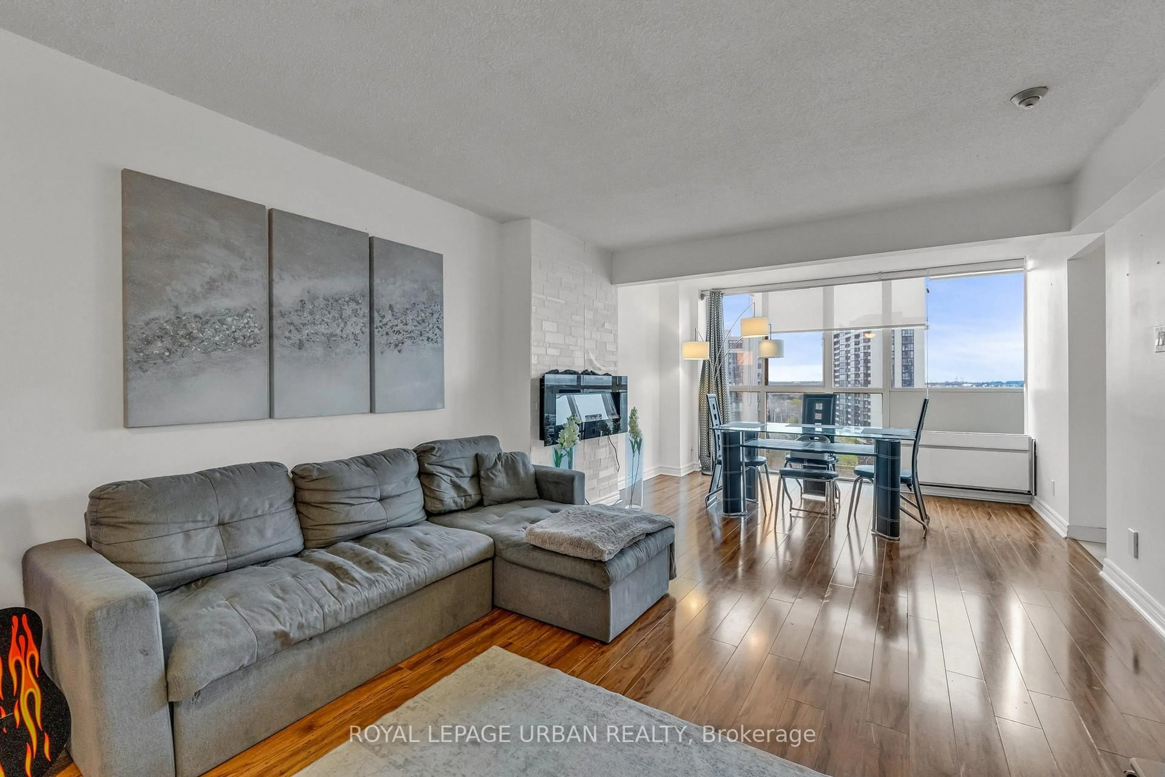 Living room with furniture, wood/laminate floor for 61 Markbrook Lane #1210, Toronto Ontario M9V 5E7