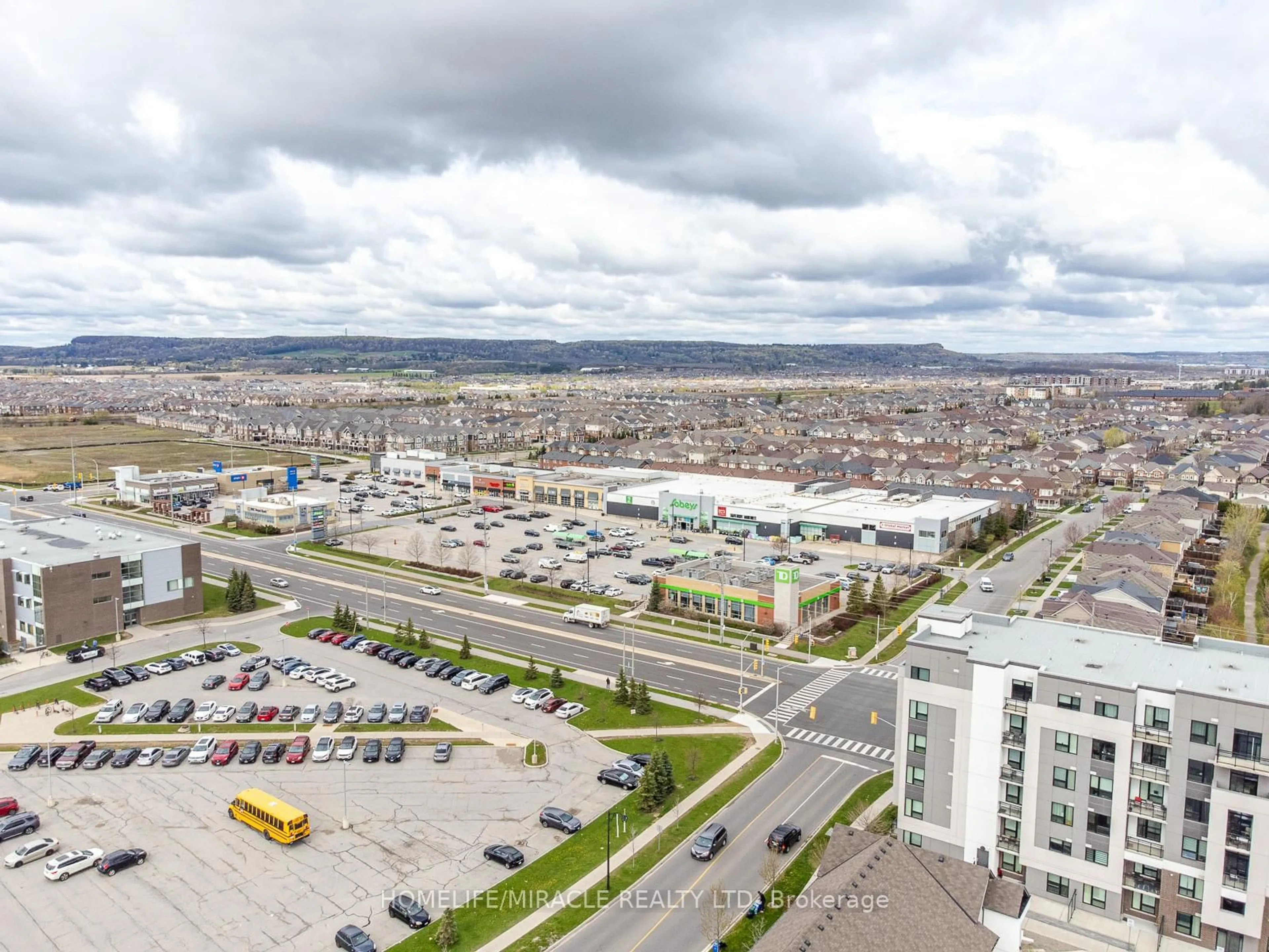 A pic from outside/outdoor area/front of a property/back of a property/a pic from drone, unknown for 1105 Leger Way #421, Milton Ontario L9E 1K7