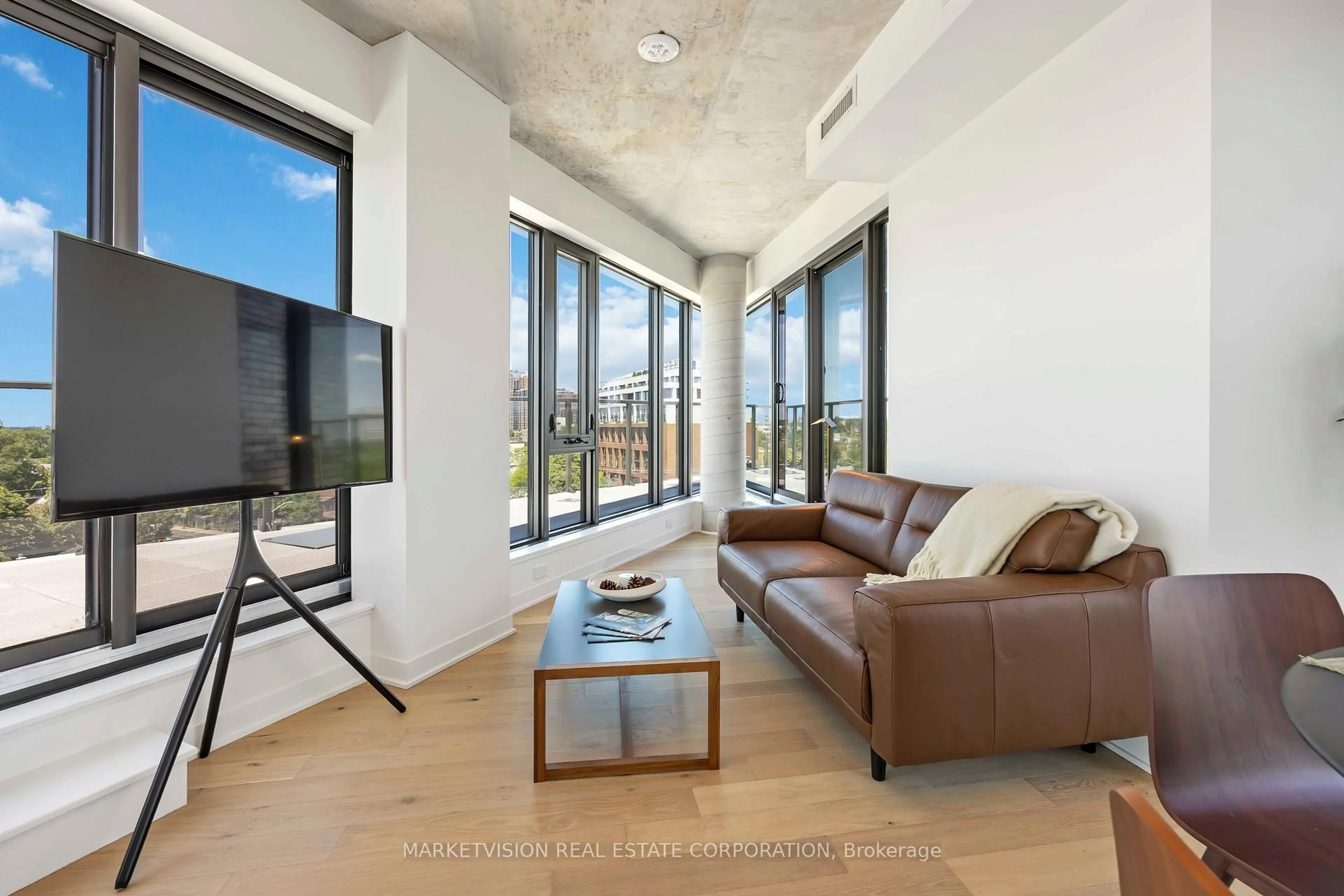 Living room with furniture, cement floor for 2625 Dundas St #705, Toronto Ontario M6P 0C5