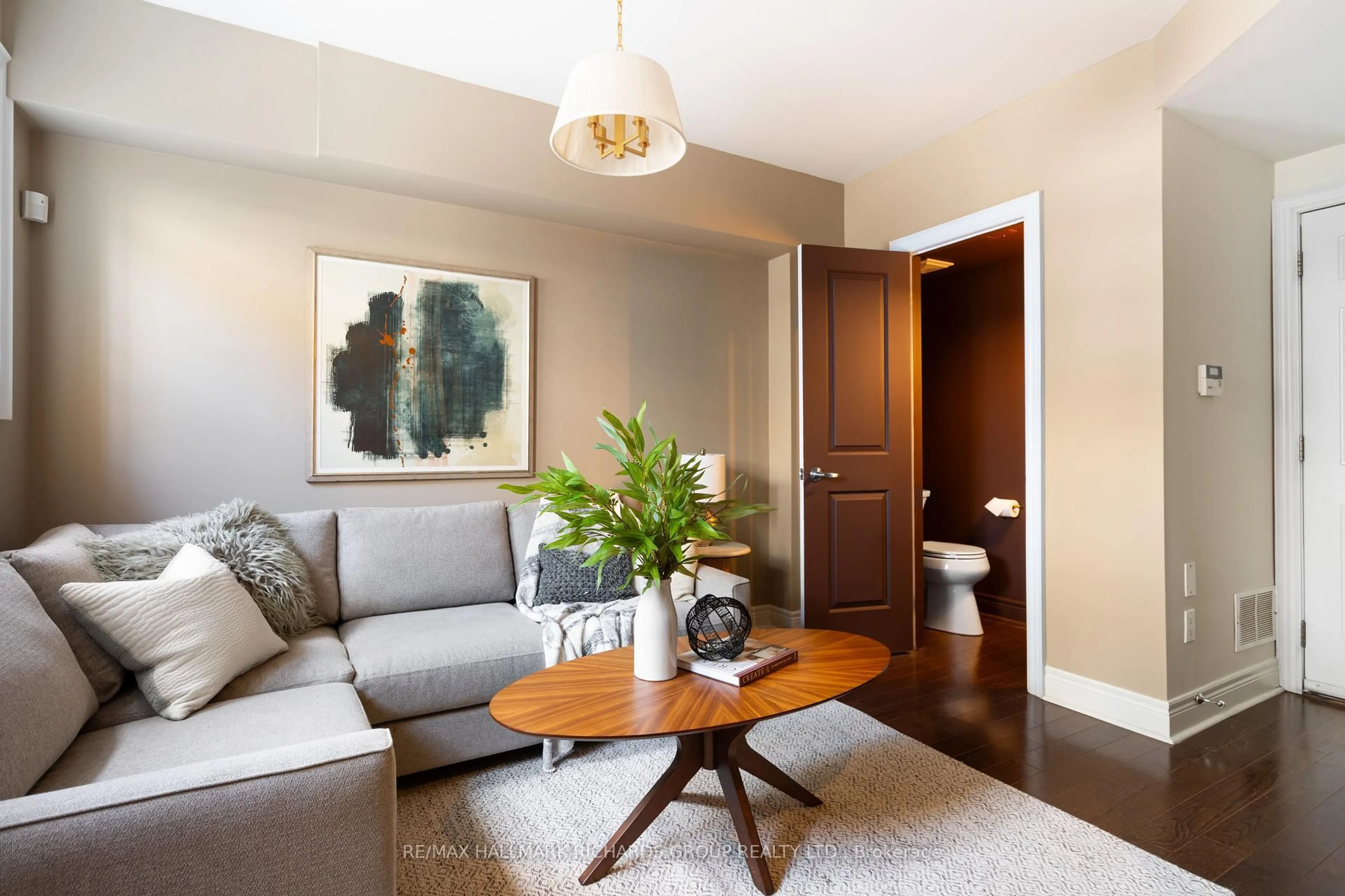 Living room with furniture, wood/laminate floor for 35 Furrow Lane, Toronto Ontario M8Z 0A2