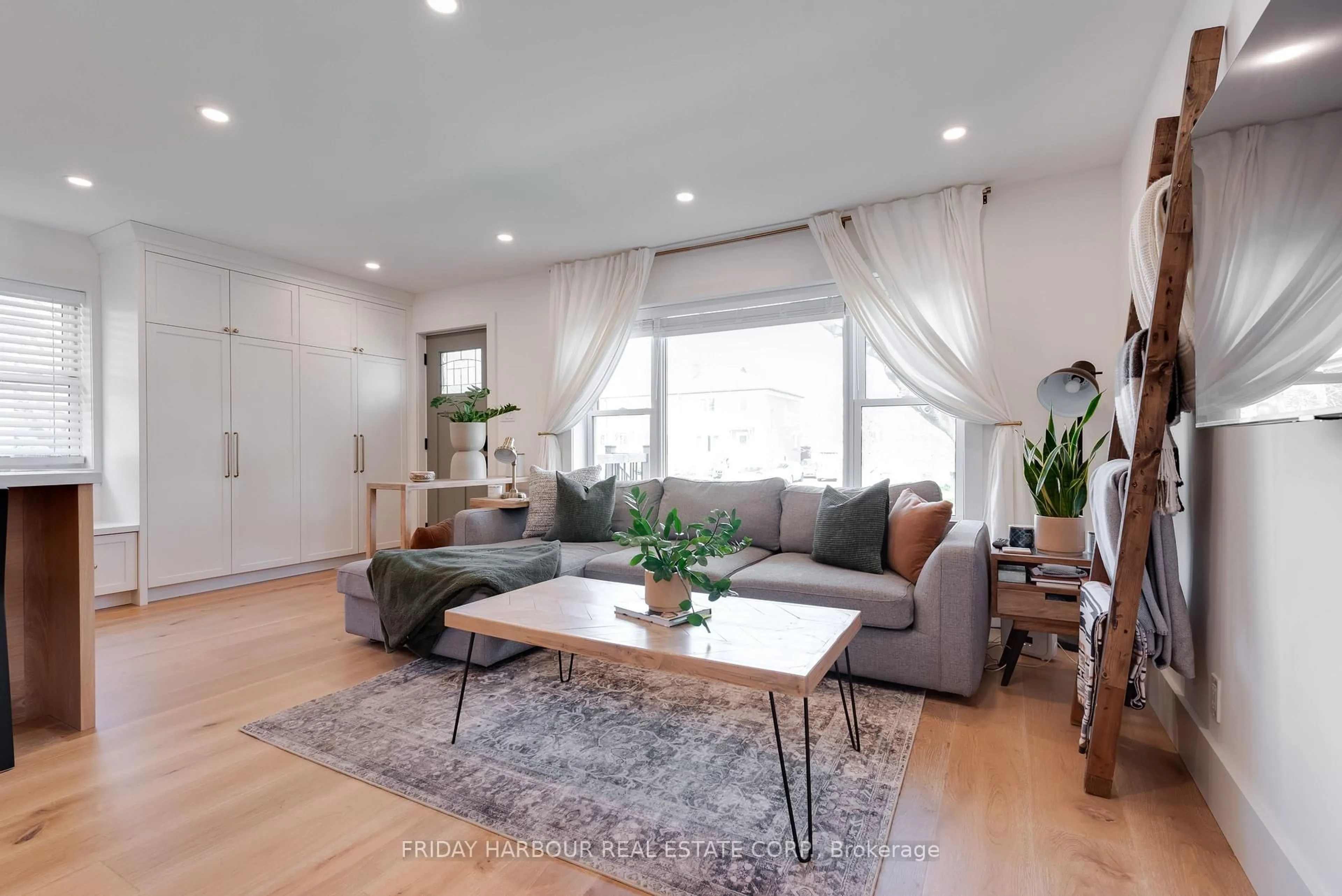 Living room with furniture, wood/laminate floor for 16 Robindale Ave, Toronto Ontario M8W 4A9