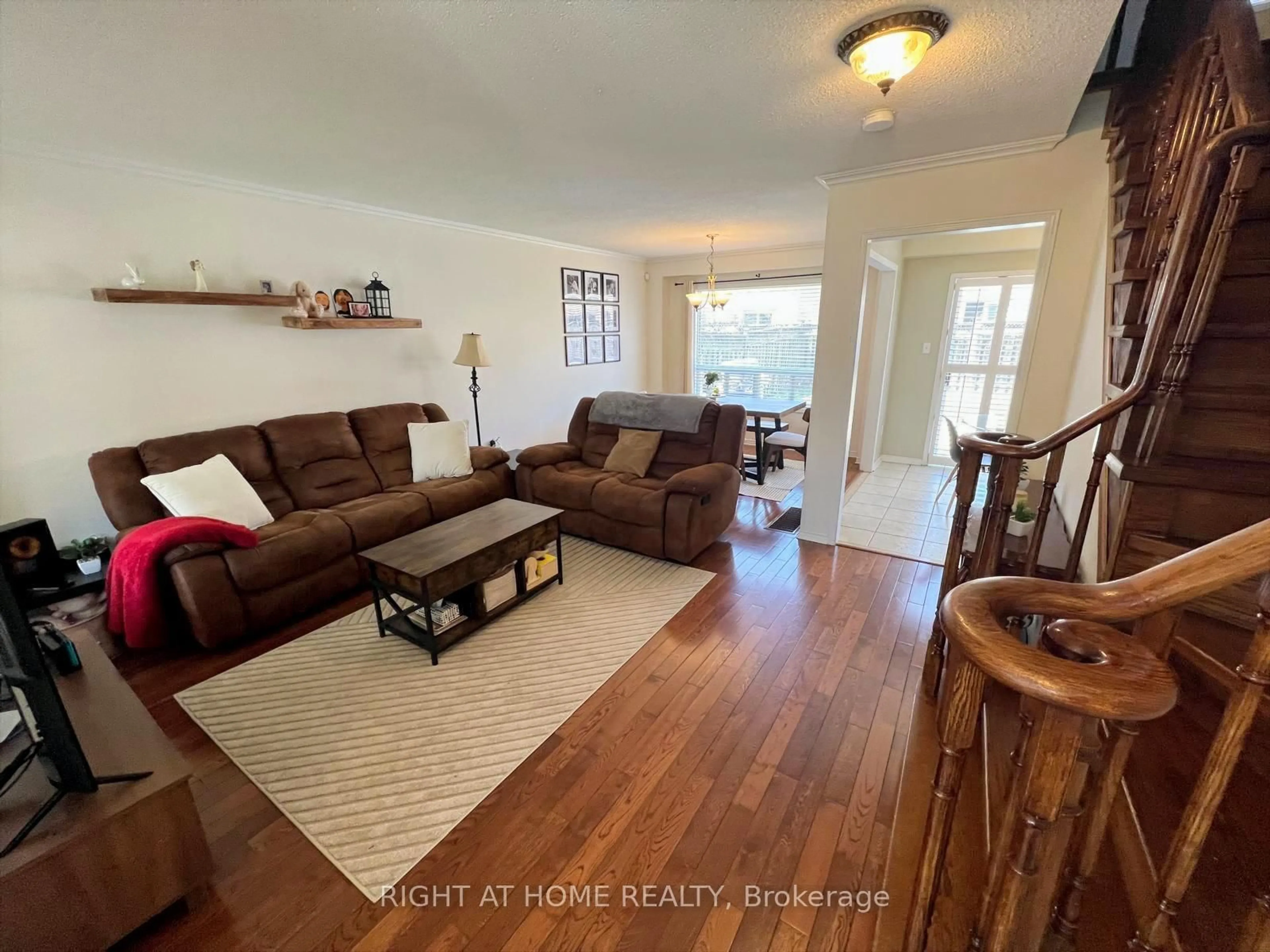 Living room with furniture, wood/laminate floor for 10 Charleswood Circ, Brampton Ontario L7A 1Z1