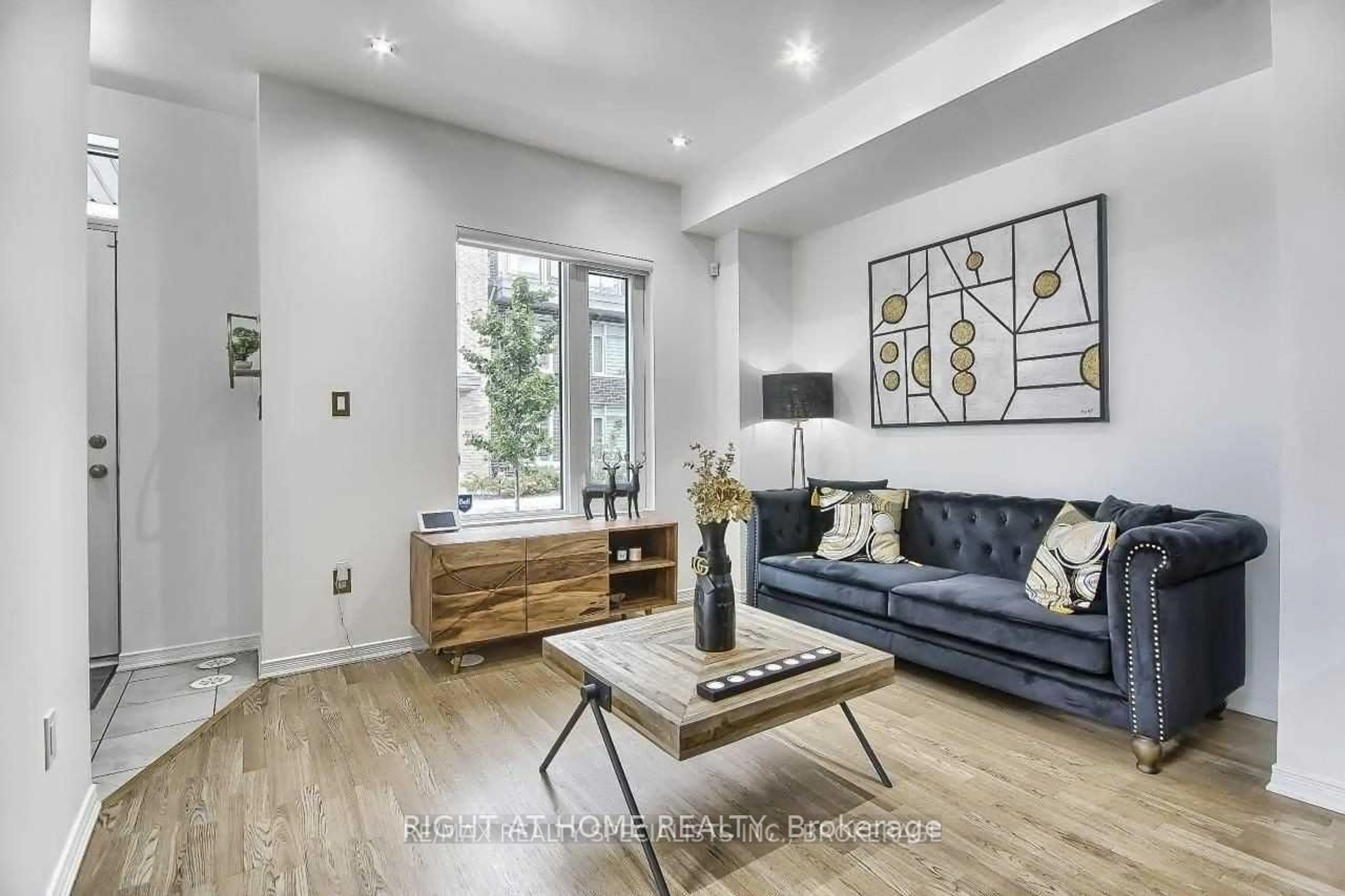 Living room with furniture, wood/laminate floor for 26 Applewood Lane #49, Toronto Ontario M9C 0C1