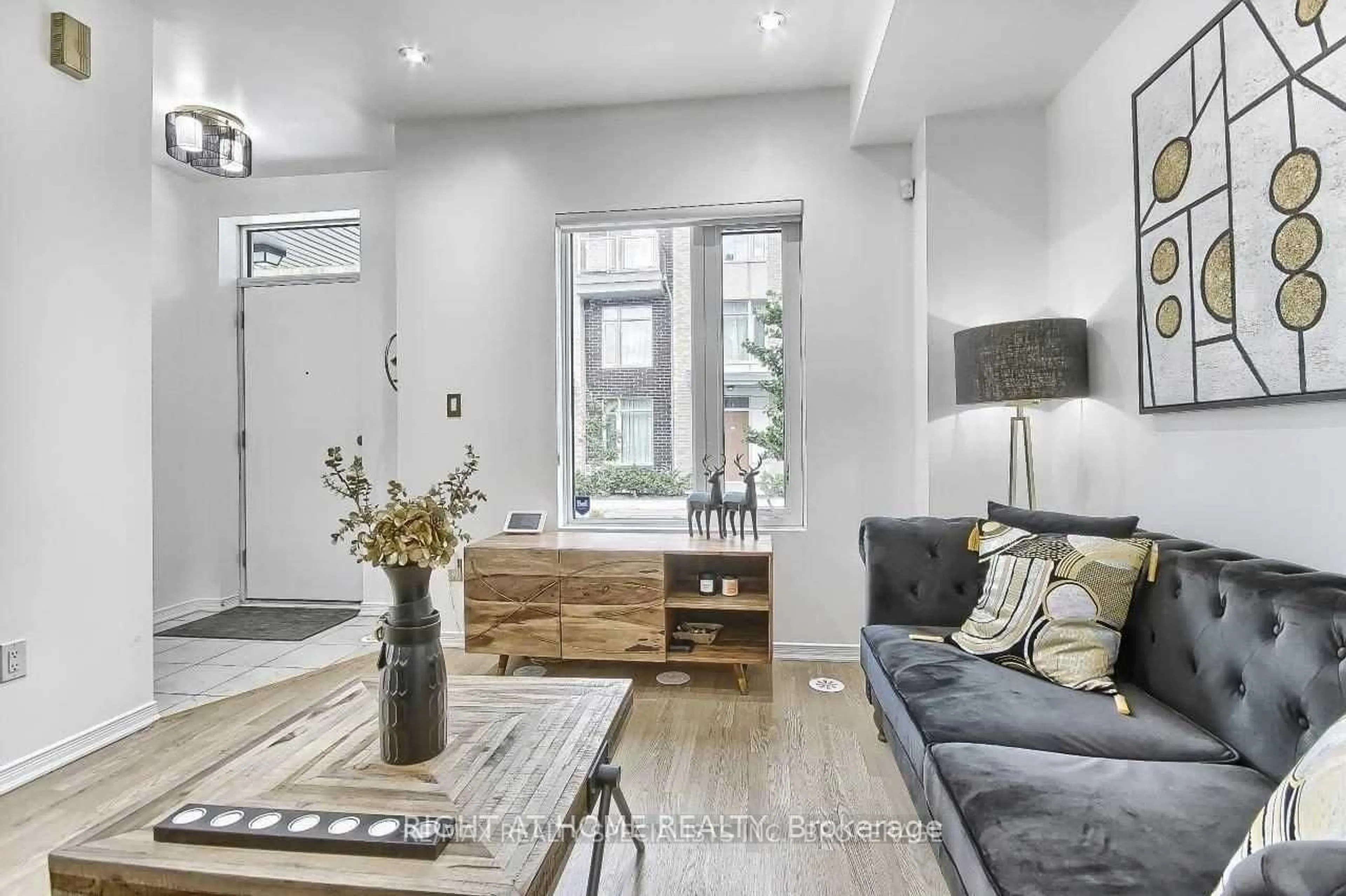 Living room with furniture, wood/laminate floor for 26 Applewood Lane #49, Toronto Ontario M9C 0C1