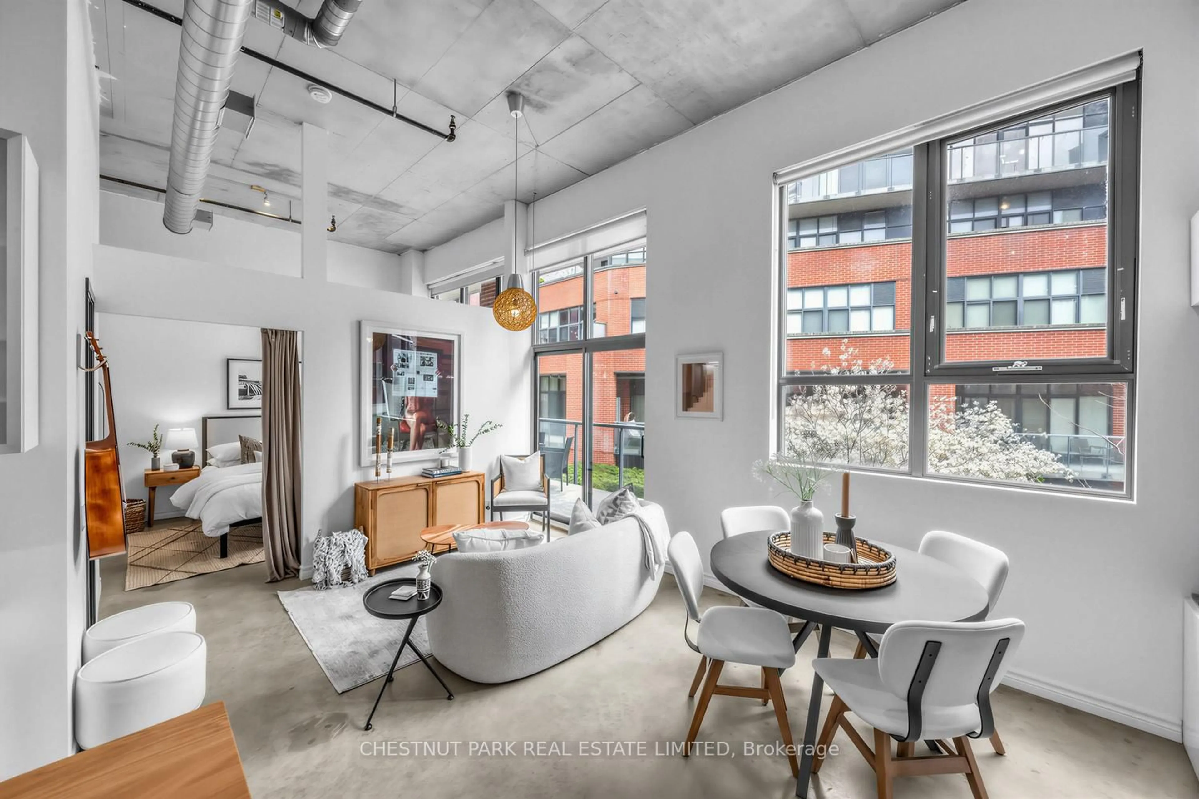 Living room with furniture, cement floor for 363 Sorauren Ave #301, Toronto Ontario M6R 3C1