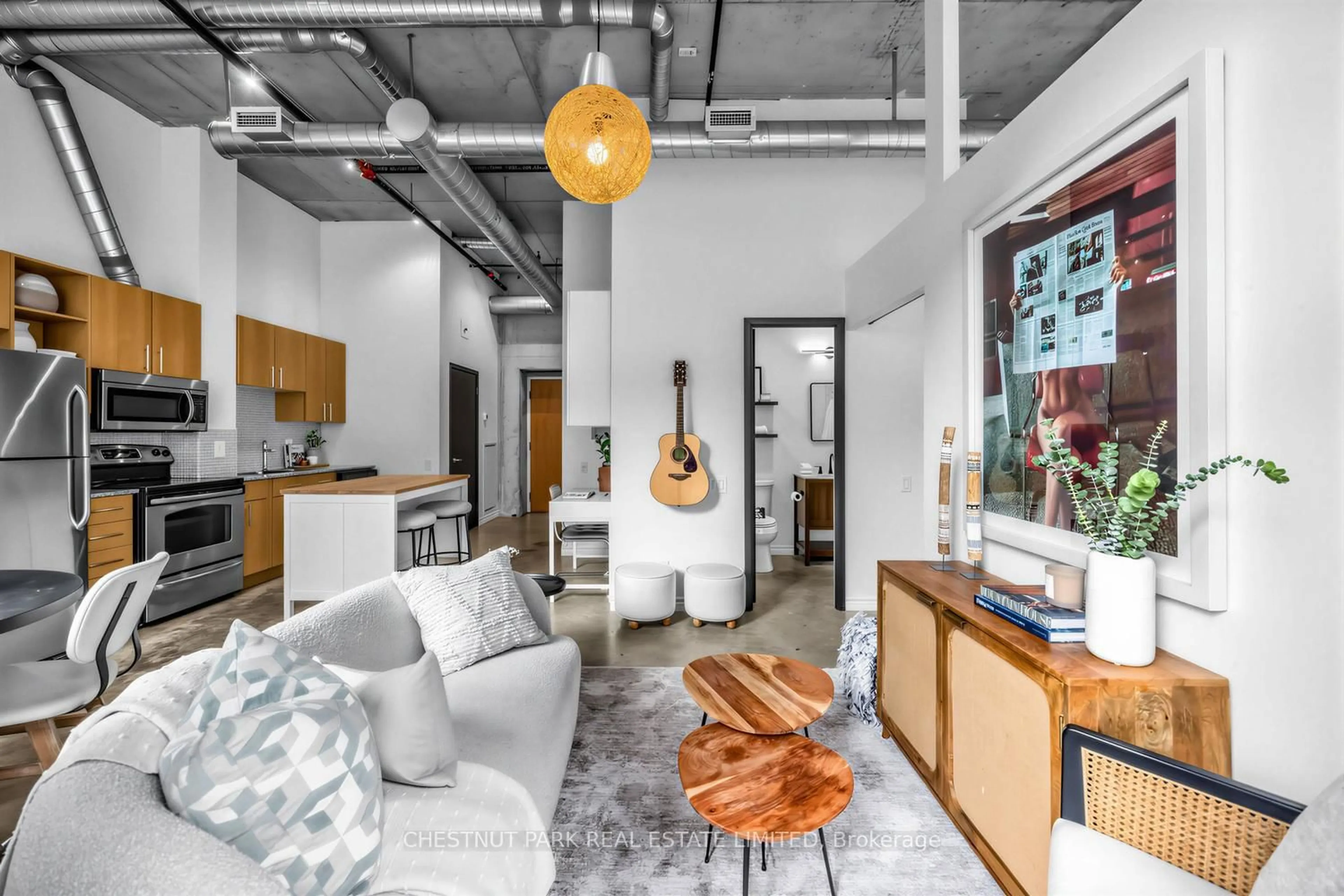 Living room with furniture, cement floor for 363 Sorauren Ave #301, Toronto Ontario M6R 3C1