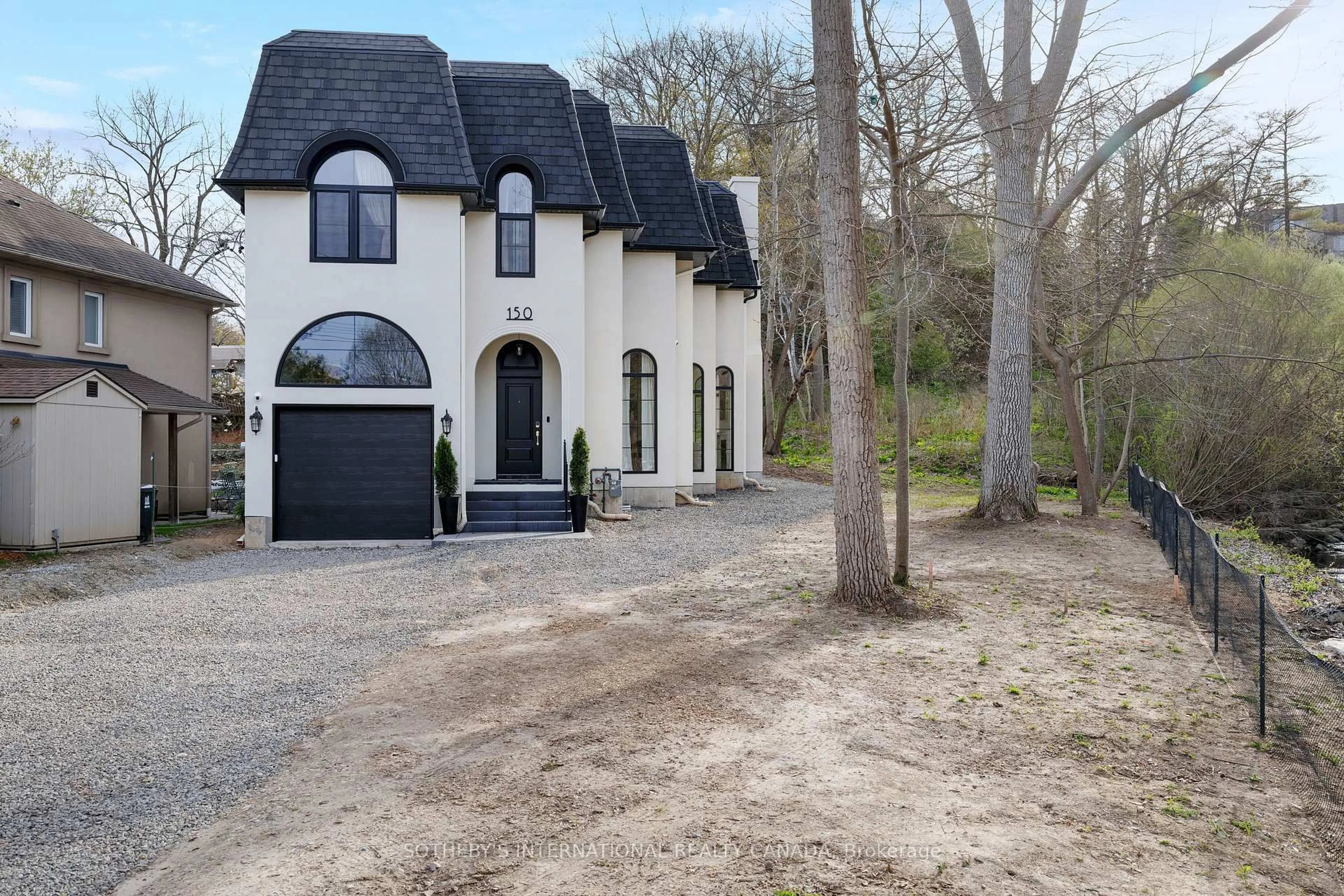 Home with brick exterior material, street for 150 Edenbridge Dr, Toronto Ontario M9A 3G6