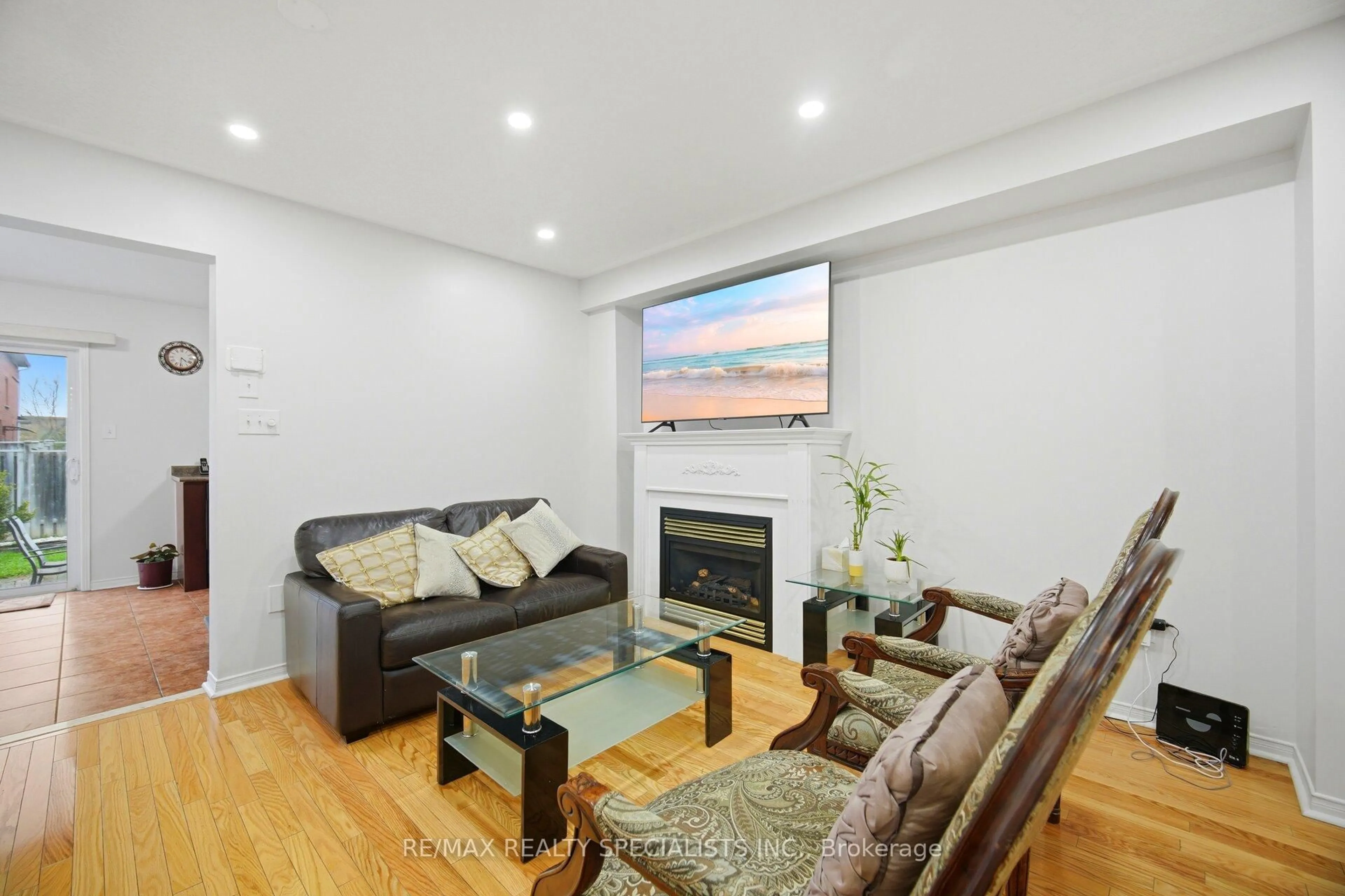 Living room with furniture, wood/laminate floor for 44 Galtee Rd, Brampton Ontario L6X 0J5