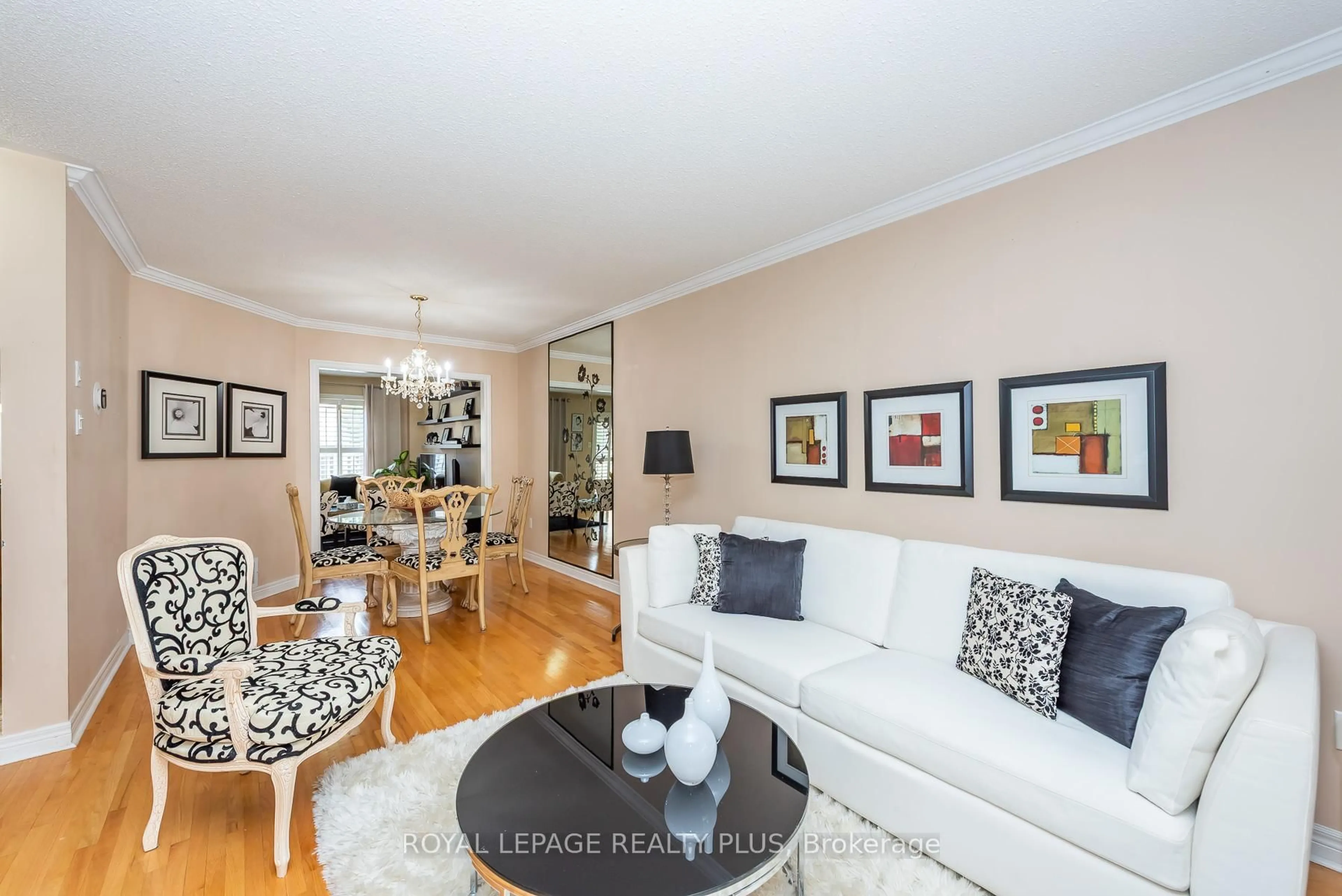 Living room with furniture, wood/laminate floor for 6943 Buttle Station Pl, Mississauga Ontario L5W 1B8
