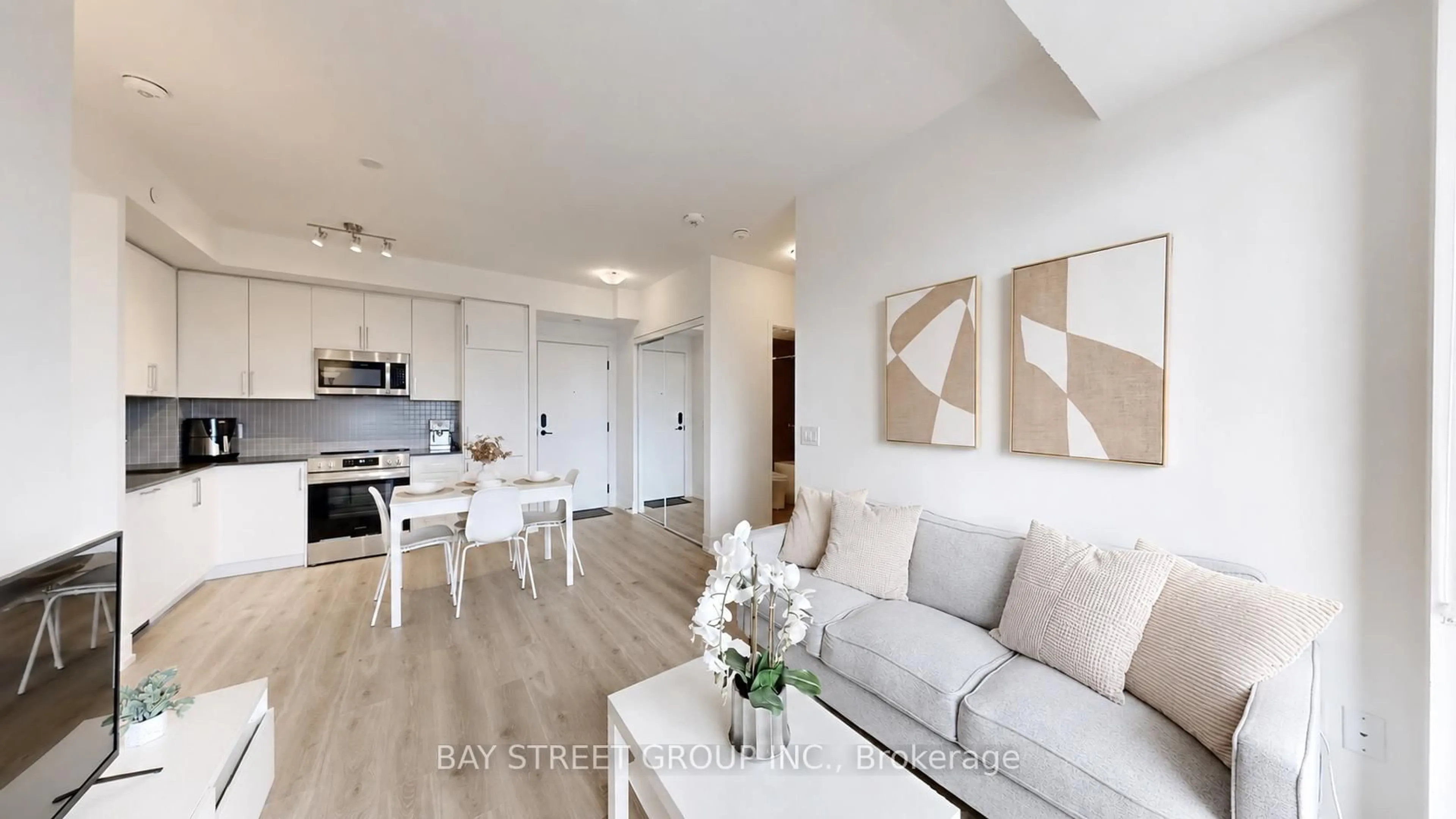 Living room with furniture, wood/laminate floor for 2450 Old Bronte Rd #710, Oakville Ontario L6M 5P6