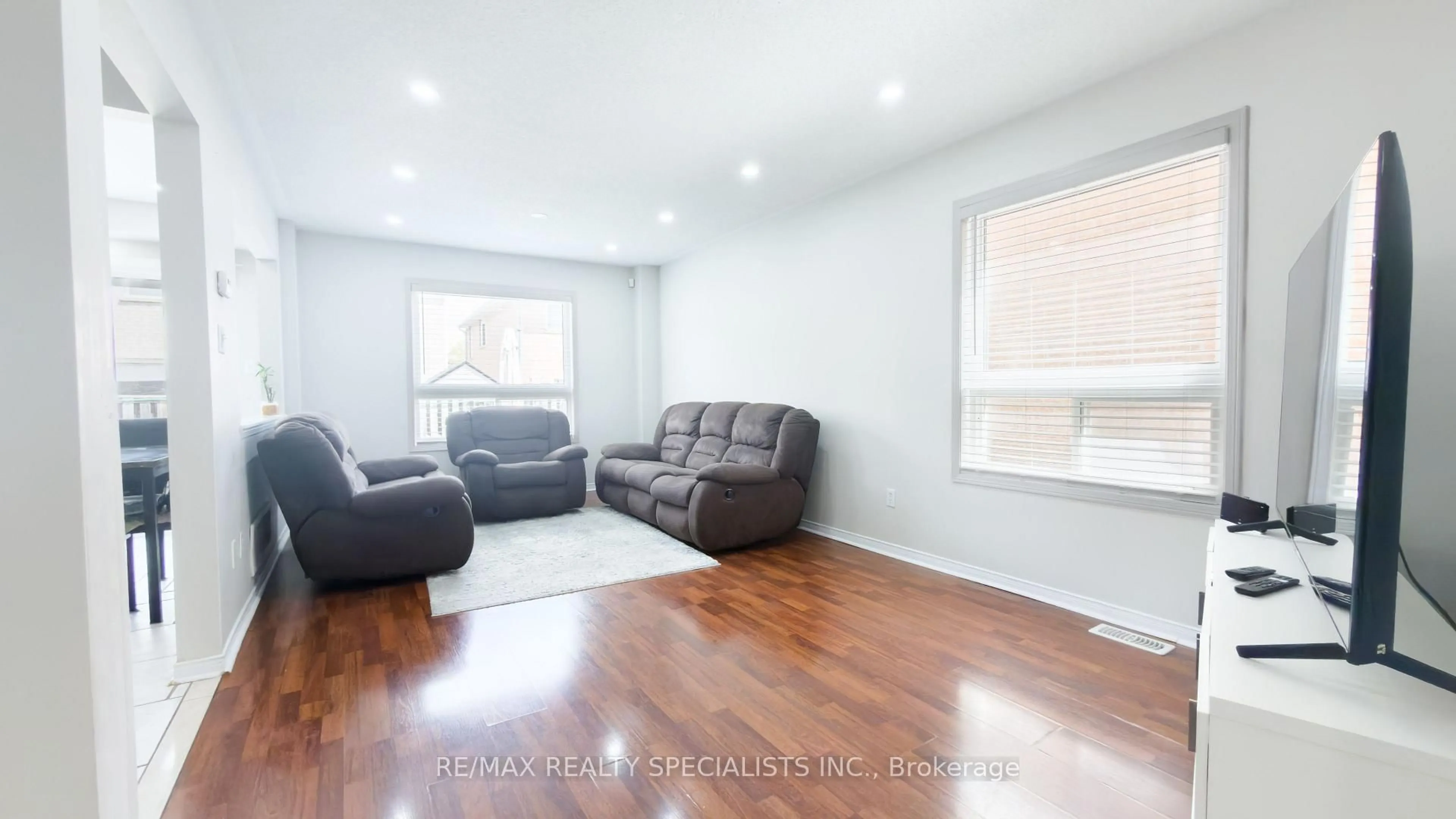 Living room with furniture, wood/laminate floor for 27 Hiberton Cres, Brampton Ontario L7A 3E2
