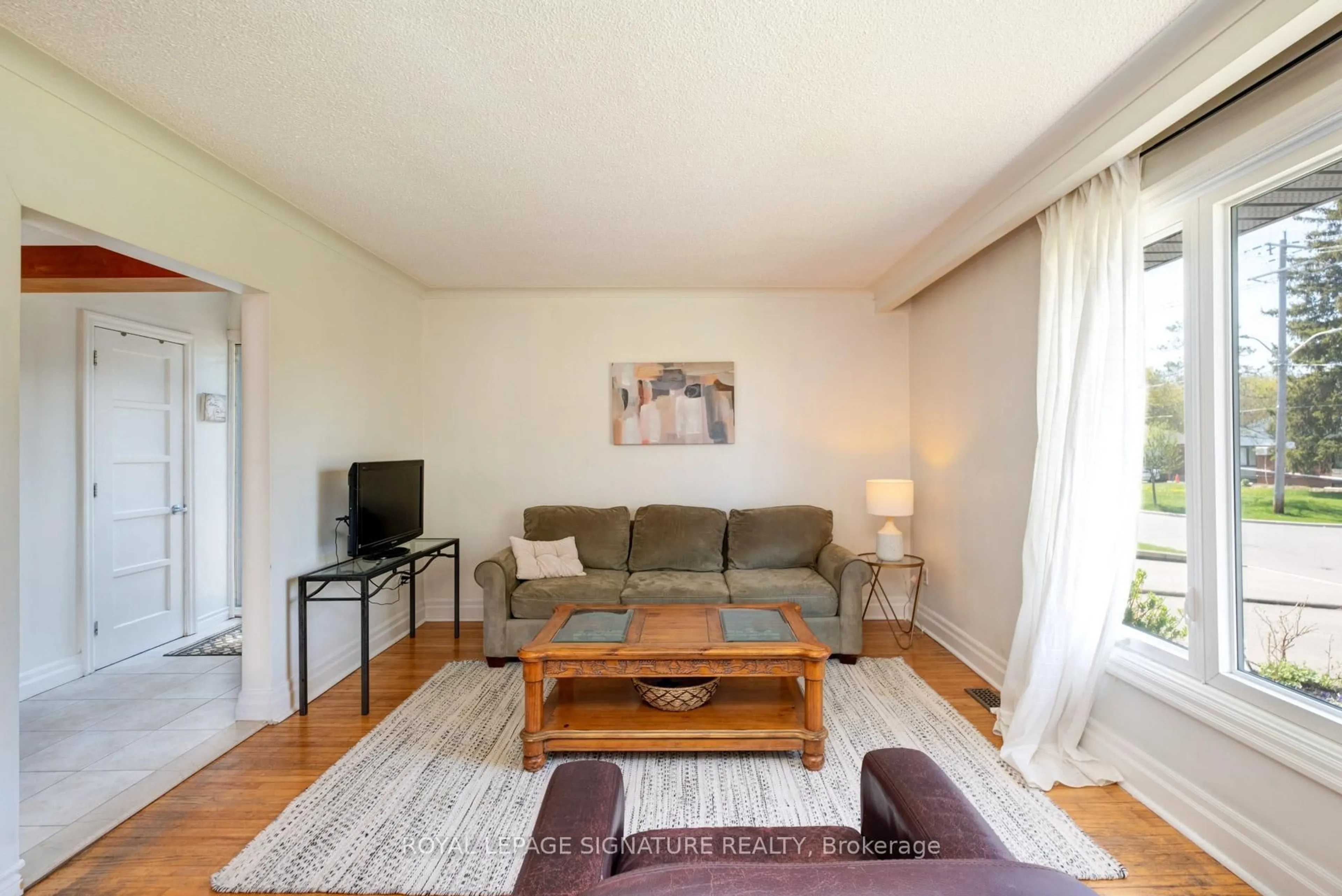 Living room with furniture, wood/laminate floor for 90 Whitburn Cres, Toronto Ontario M3H 2S4