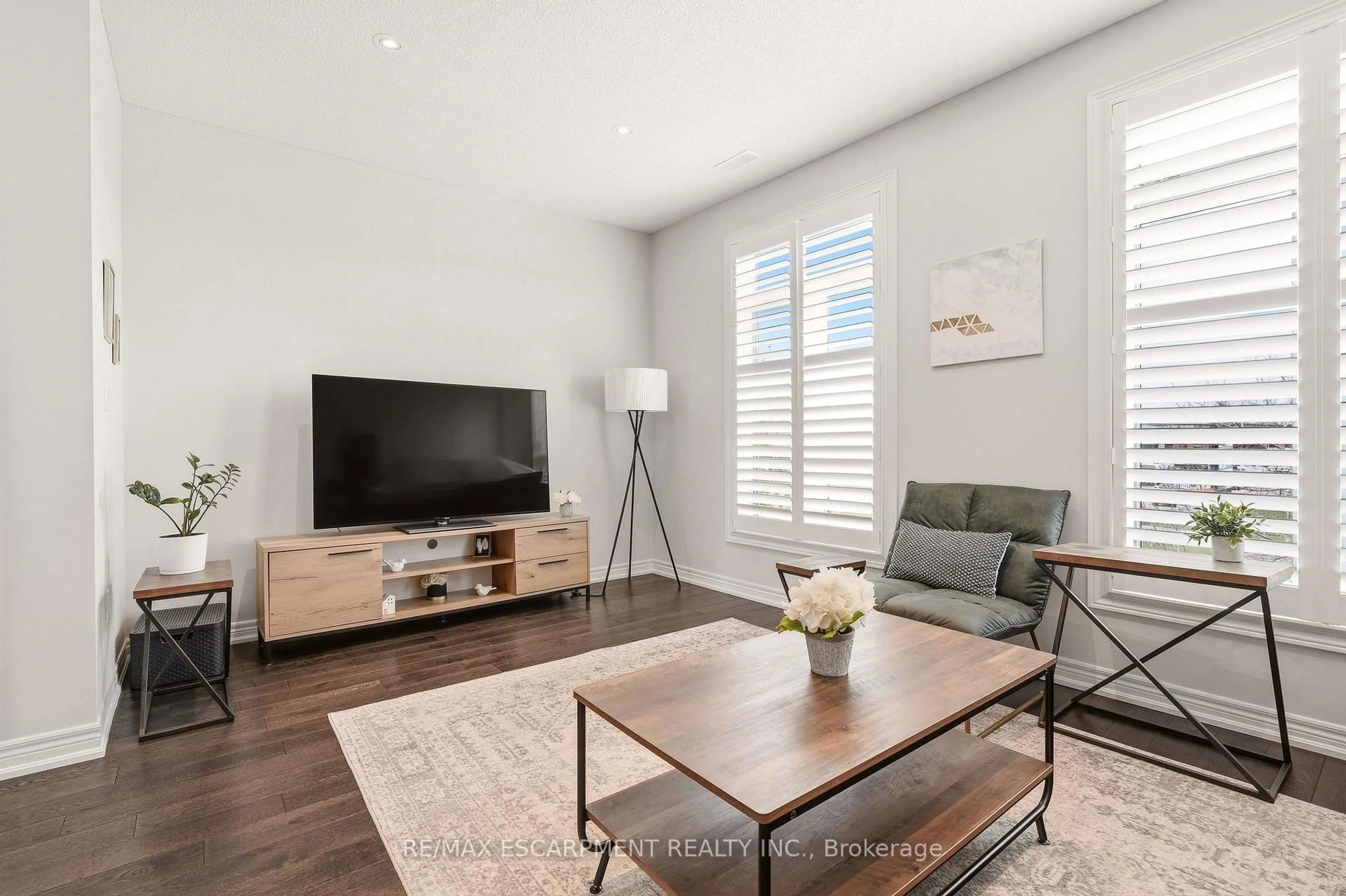 Living room with furniture, wood/laminate floor for 4171 Palermo Common #39, Burlington Ontario L7L 0G7