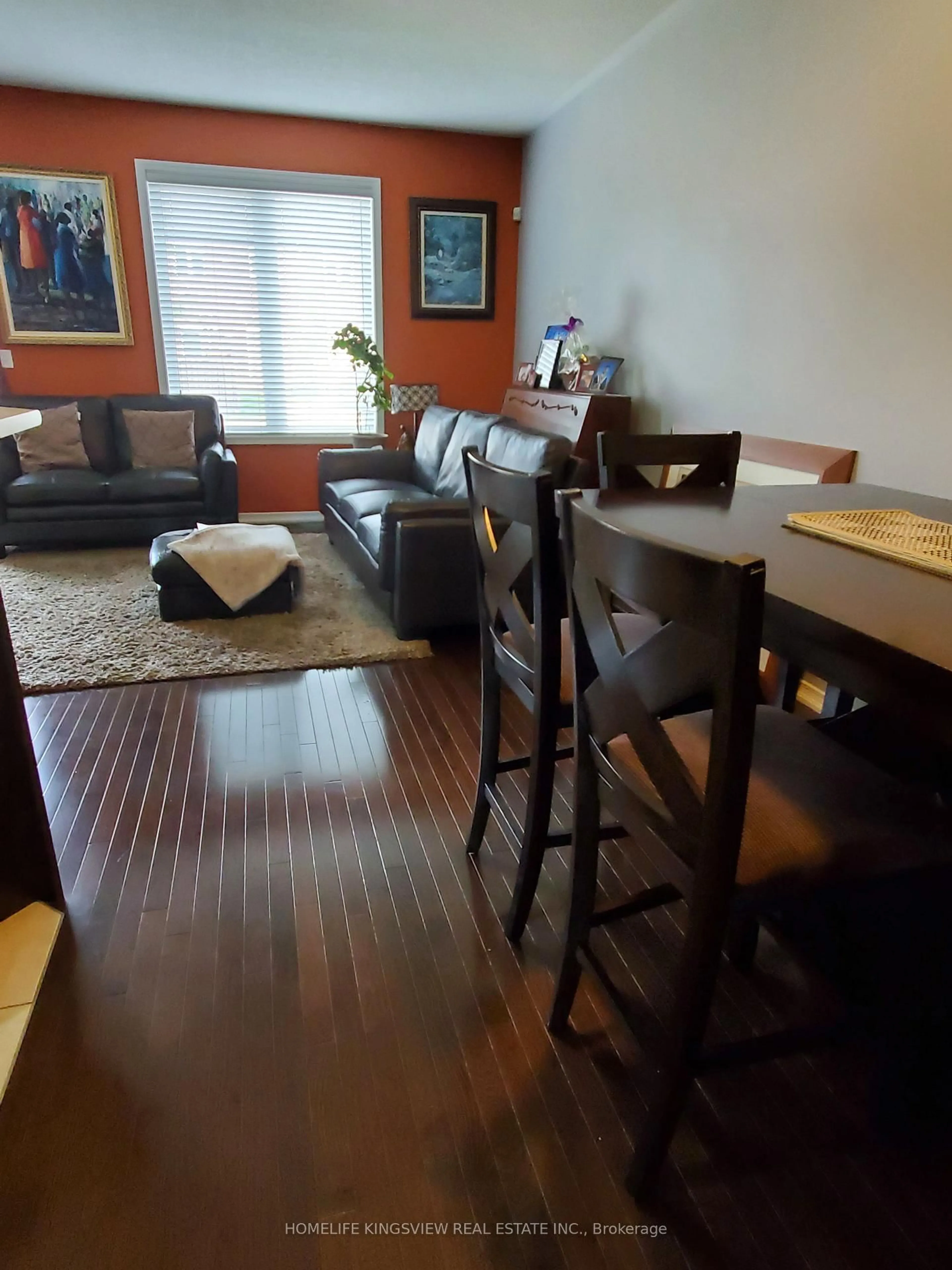 Living room with furniture, wood/laminate floor for 651 Farmstead Dr #59, Milton Ontario L9T 7W2