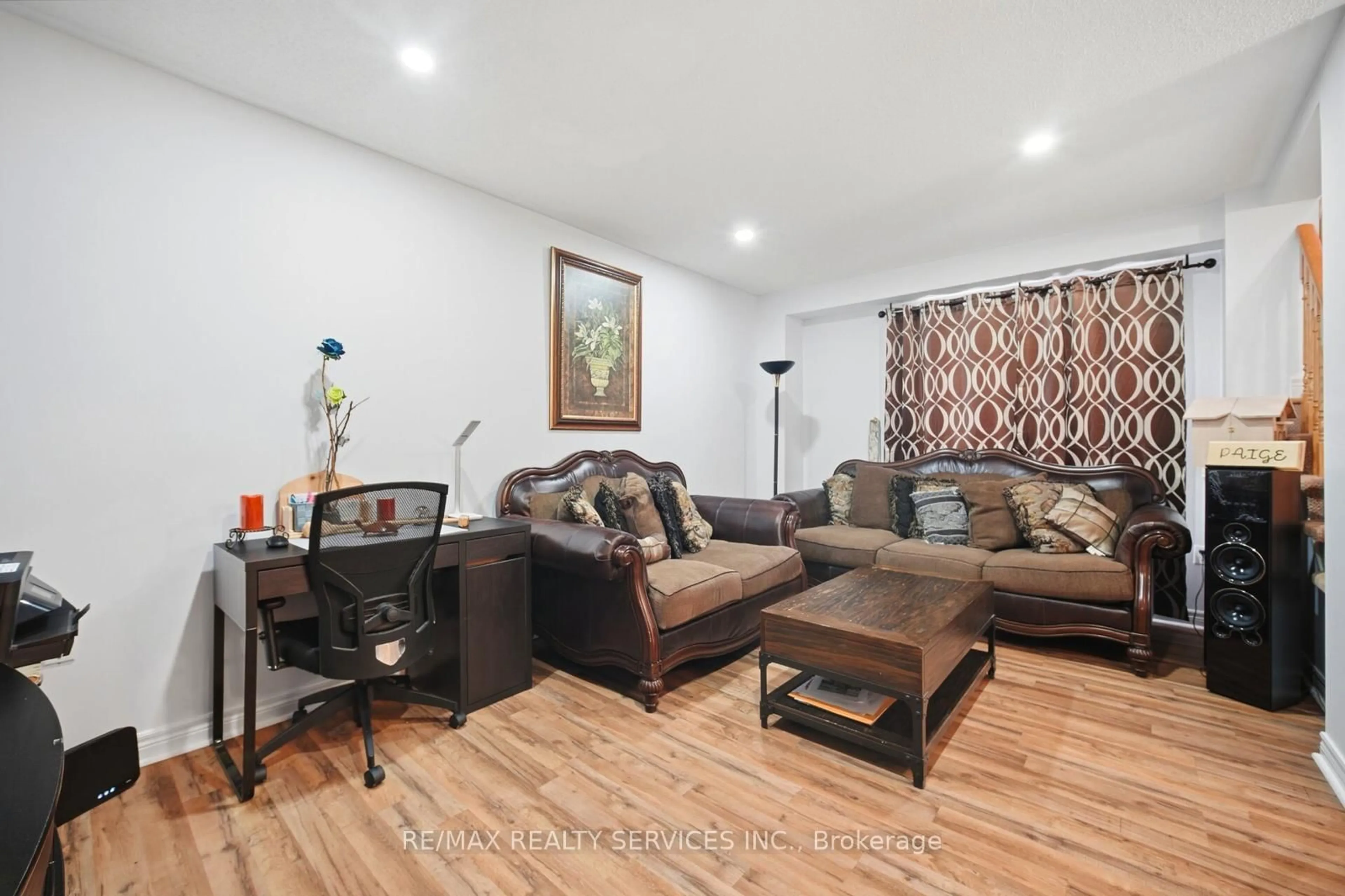Living room with furniture, wood/laminate floor for 79 Pressed Brick Dr, Brampton Ontario L6V 4K5