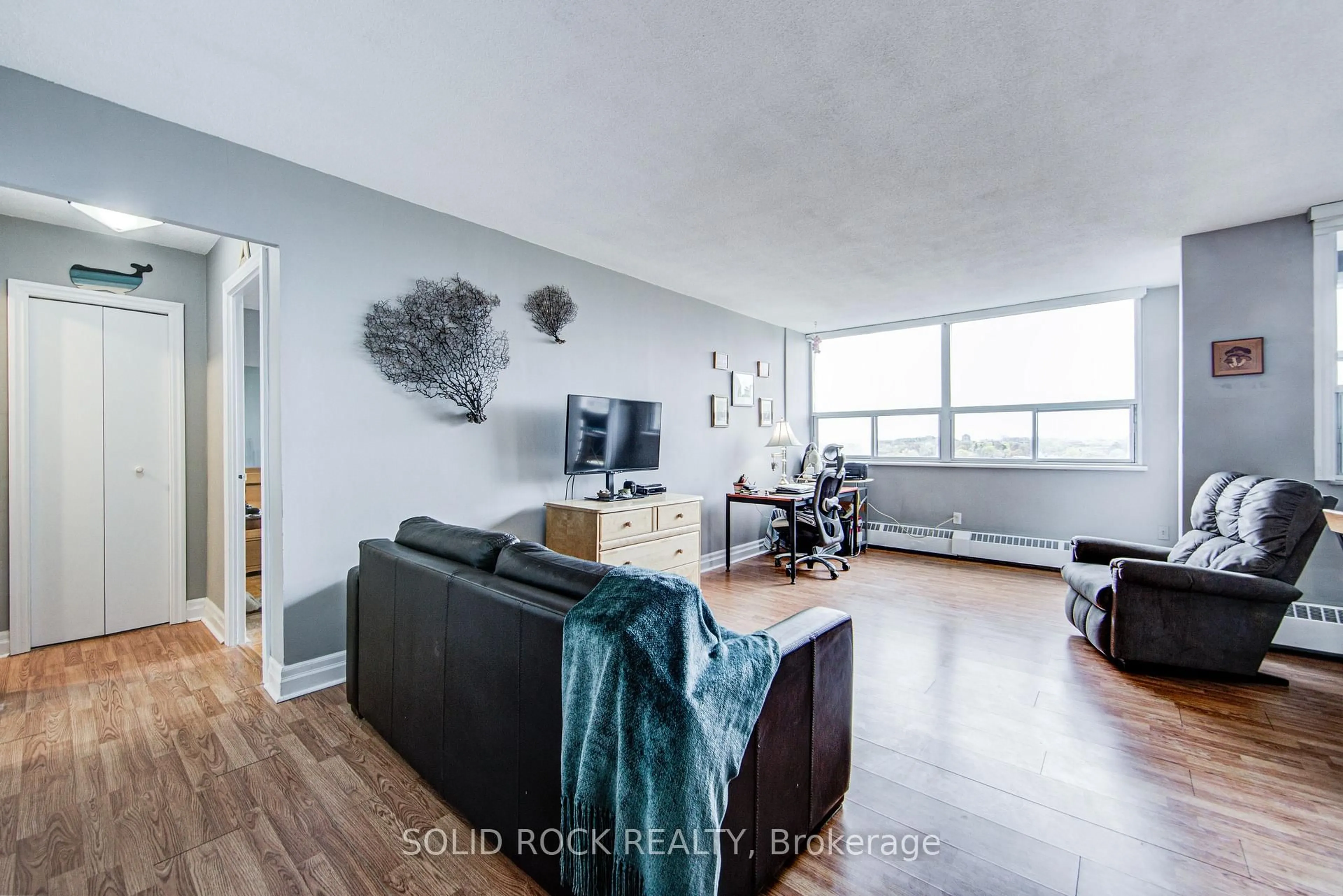 Living room with furniture, wood/laminate floor for 451 The West Mall #810, Toronto Ontario M9C 1G1