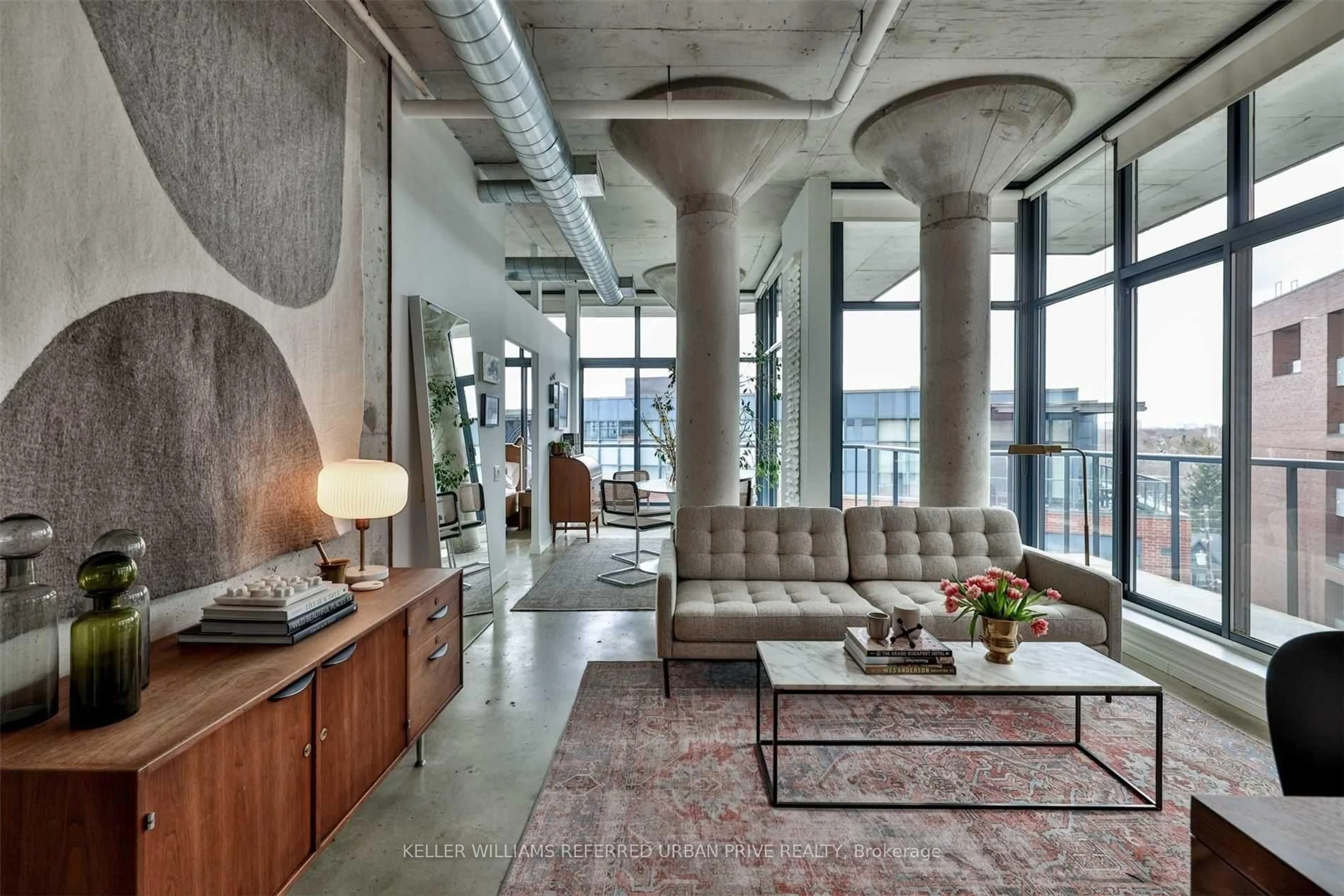 Living room with furniture, cement floor for 369 Sorauren Ave #602, Toronto Ontario M6R 3C2