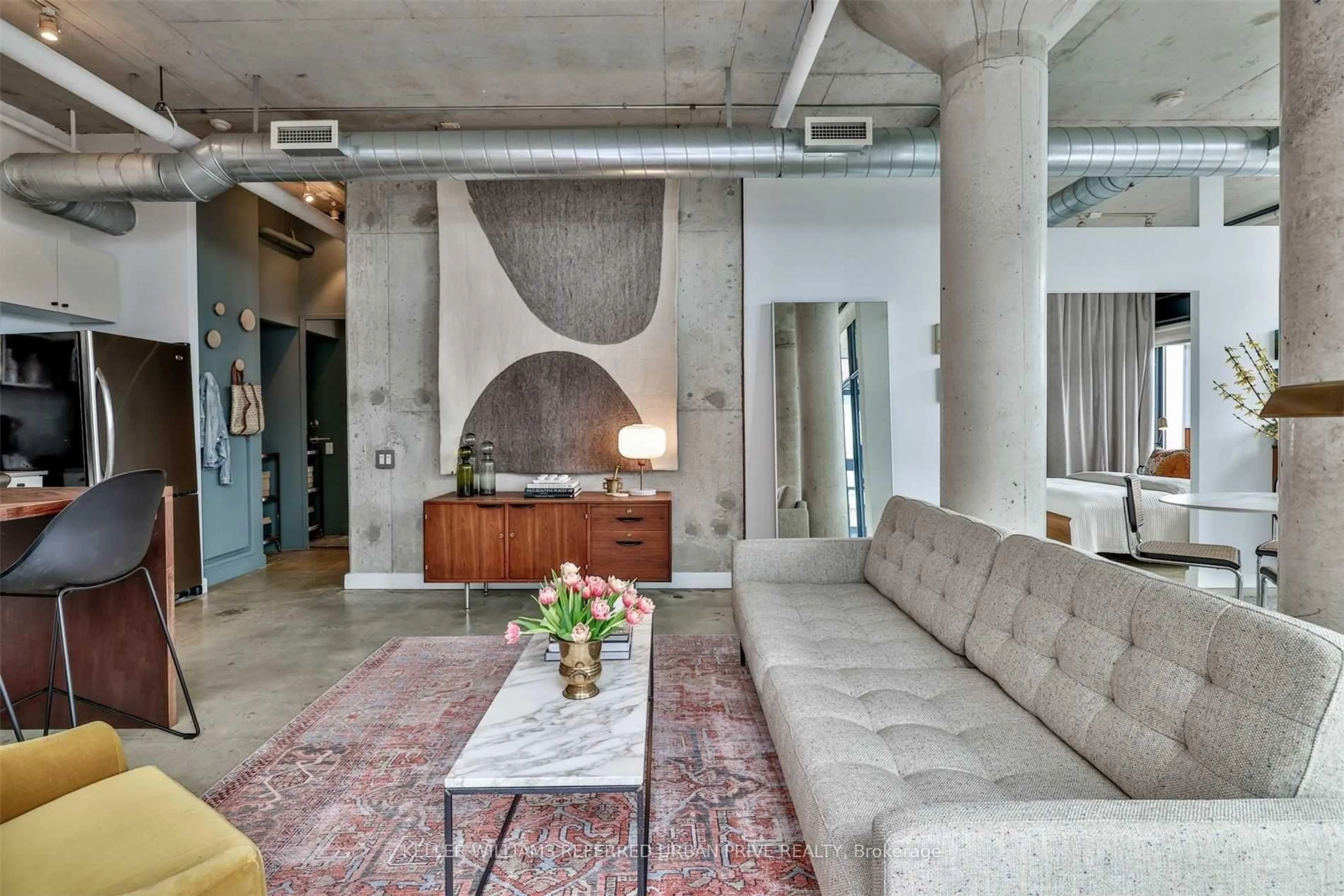 Living room with furniture, cement floor for 369 Sorauren Ave #602, Toronto Ontario M6R 3C2