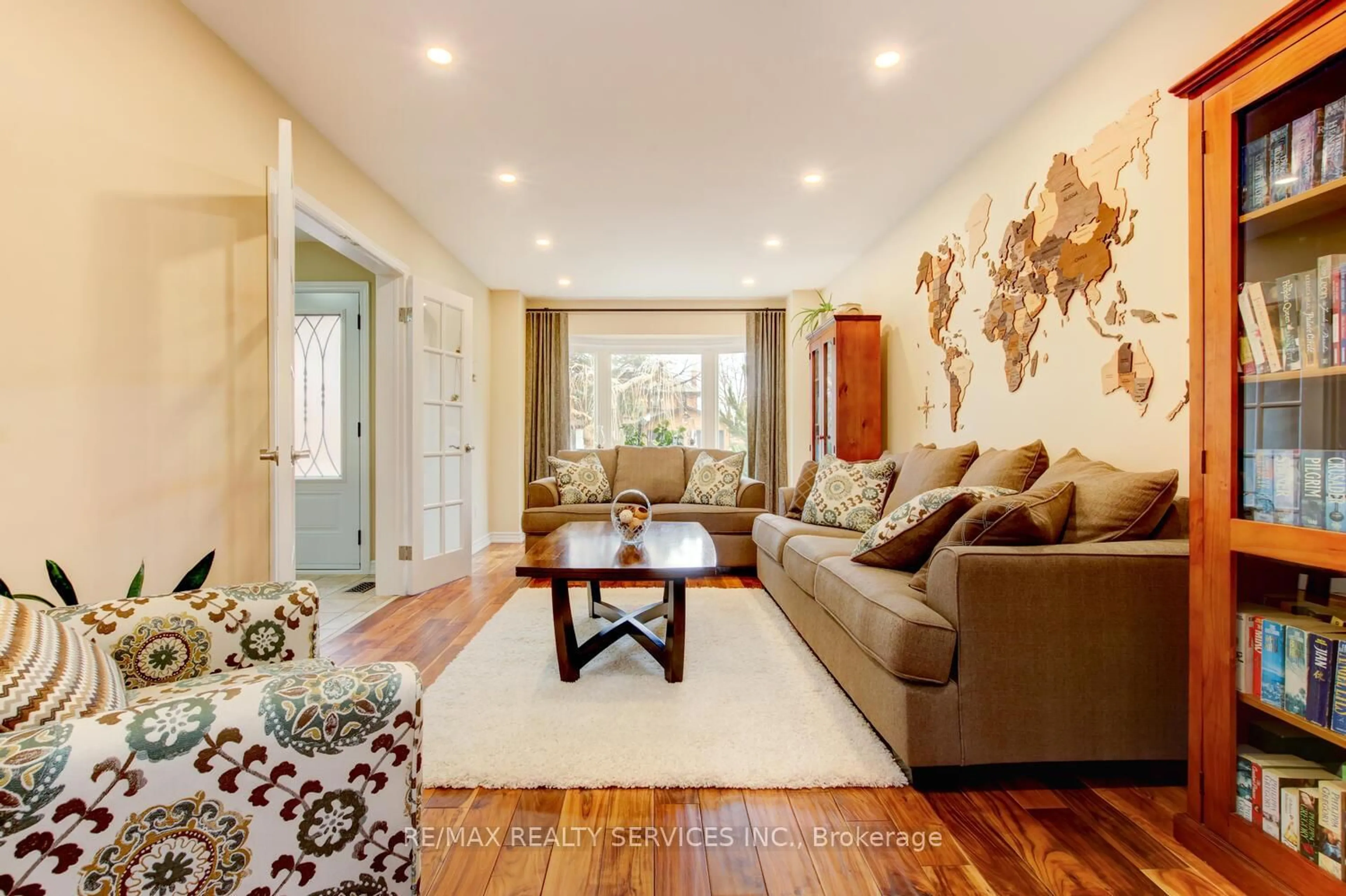 Living room with furniture, wood/laminate floor for 28 Chickadee Cres, Brampton Ontario L6Z 3L2
