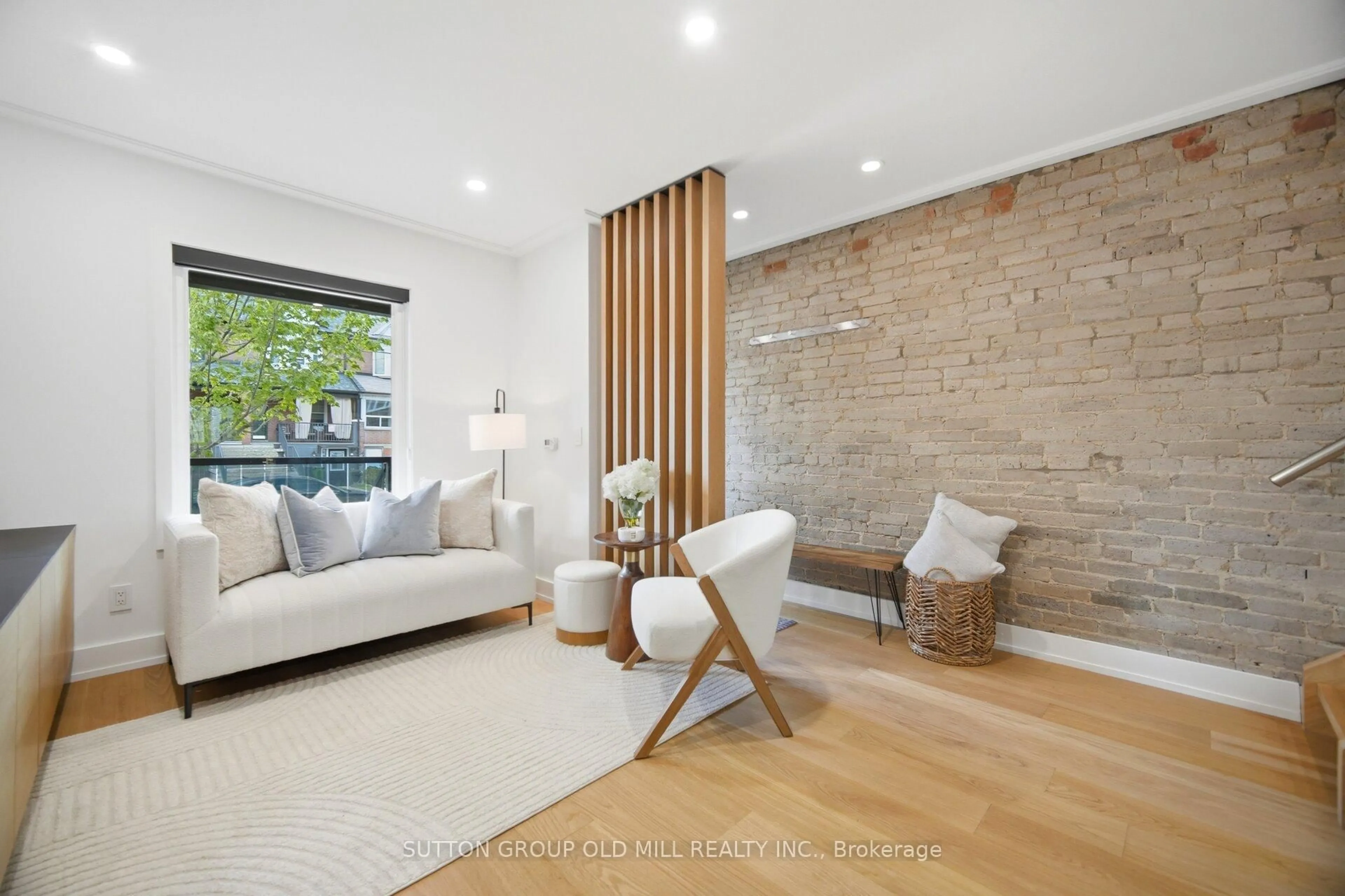 Living room with furniture, wood/laminate floor for 87 Mackay Ave, Toronto Ontario M6H 2N7