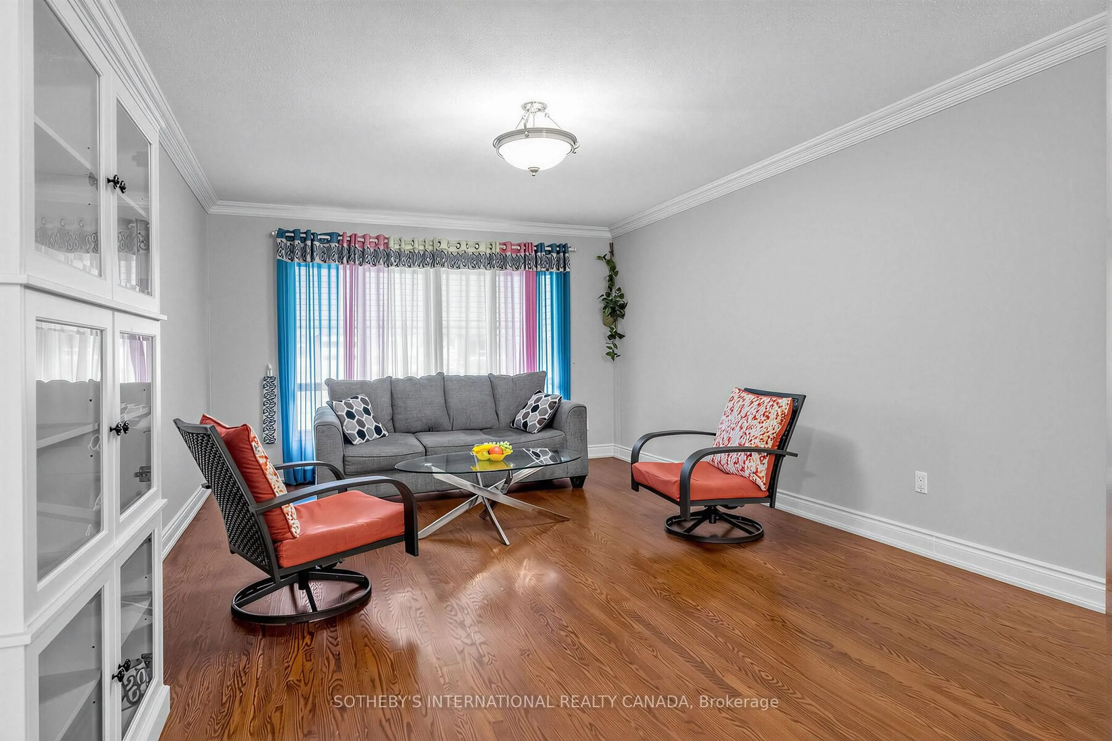 Living room with furniture, wood/laminate floor for 3352 Queen Frederica Dr, Mississauga Ontario L4Y 3B2