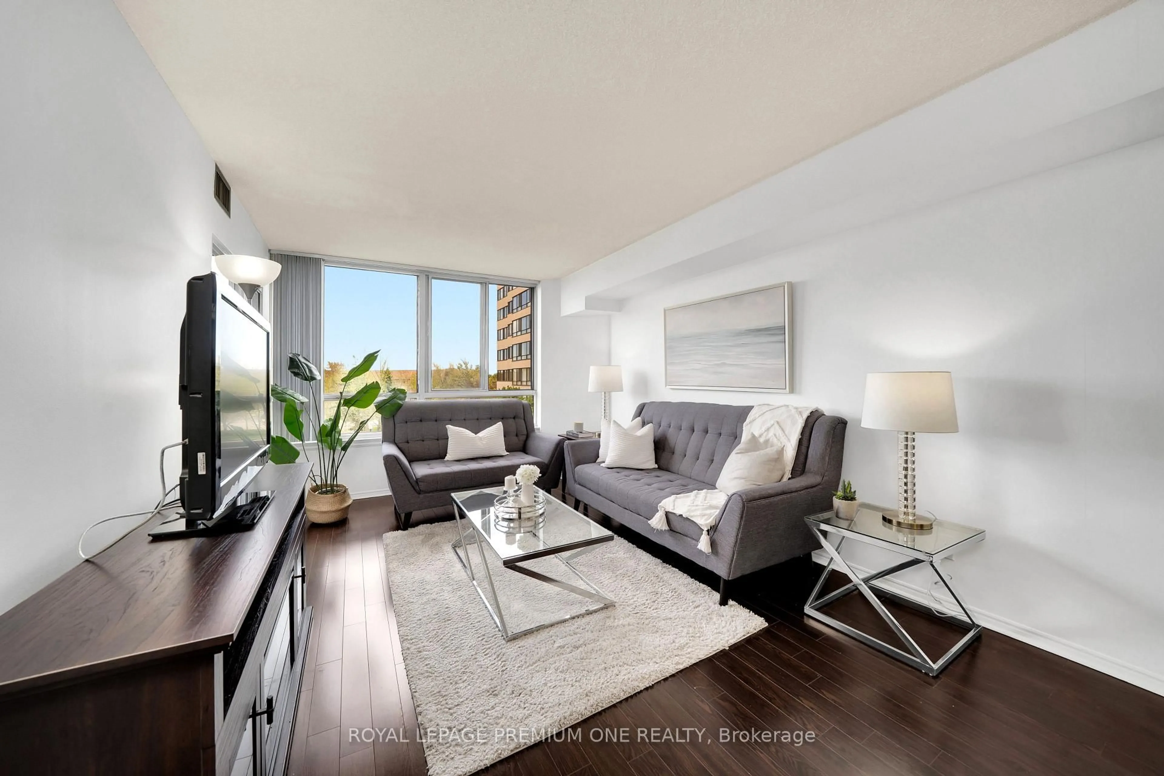 Living room with furniture, wood/laminate floor for 1001 cedarglen Gate #310, Mississauga Ontario L5C 4R2