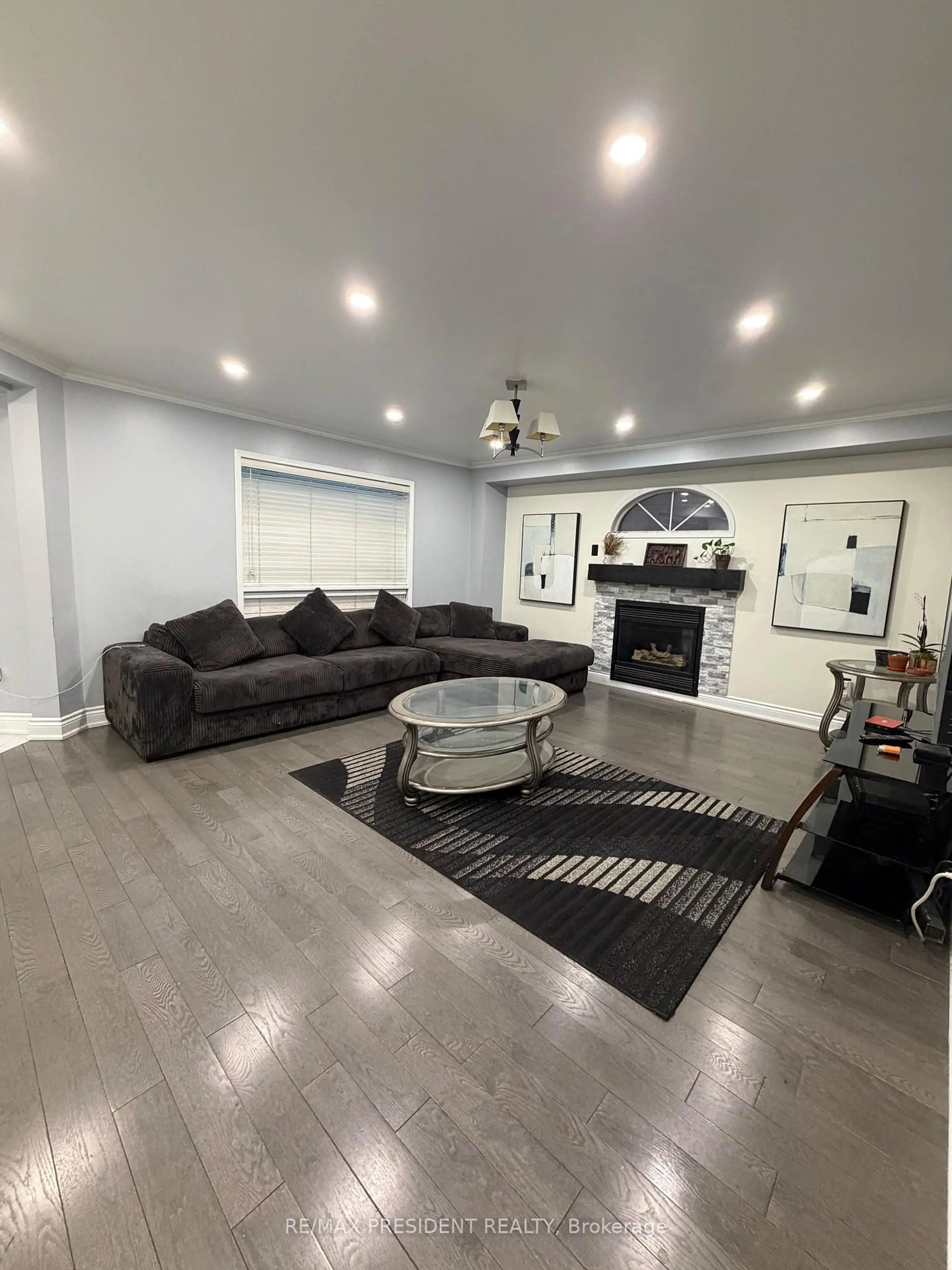 Living room with furniture, wood/laminate floor for 31 Southbend Dr, Brampton Ontario L7A 1K5