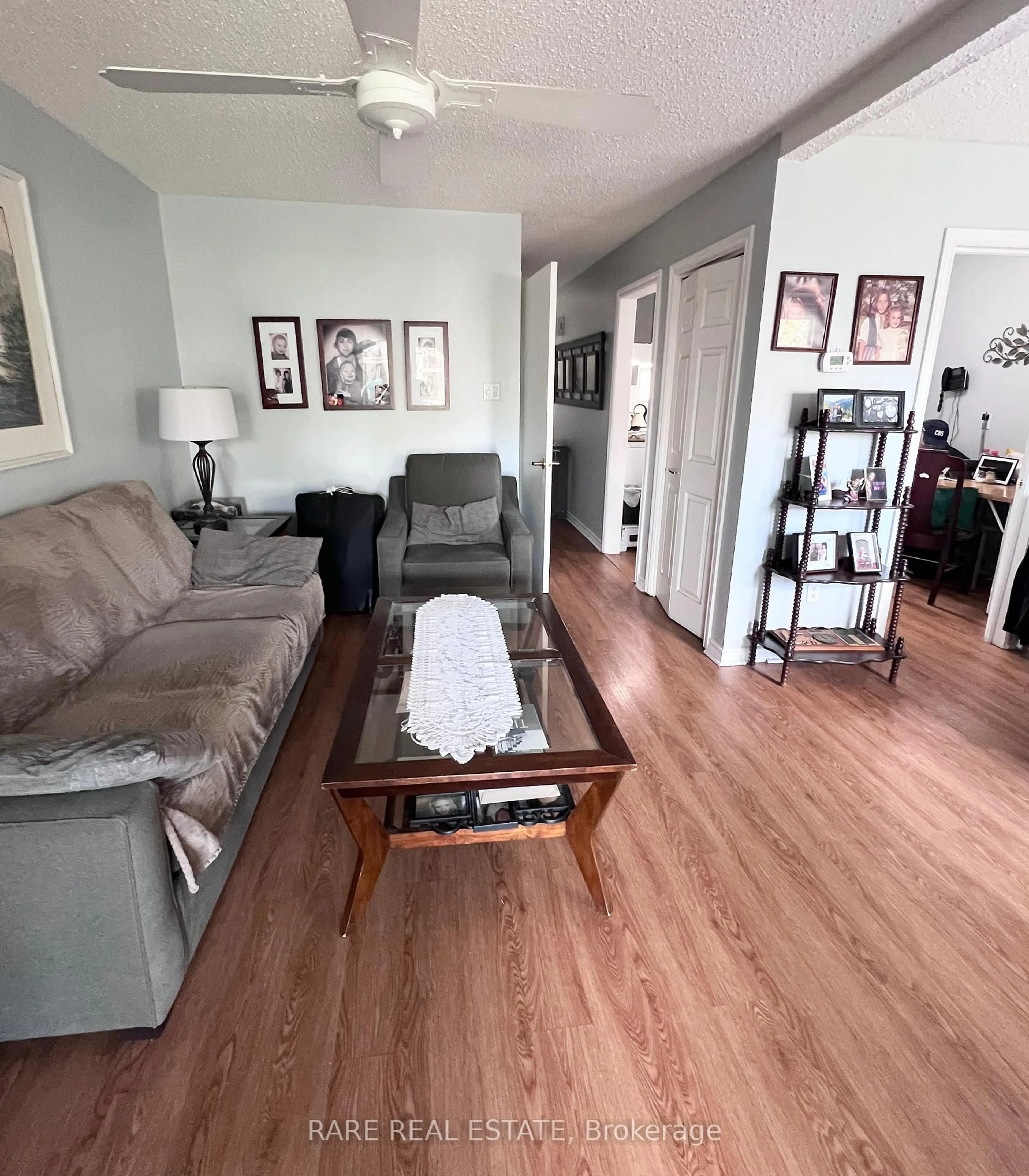 Living room with furniture, wood/laminate floor for 206 Royal Salisbury Way, Brampton Ontario L6V 3J9