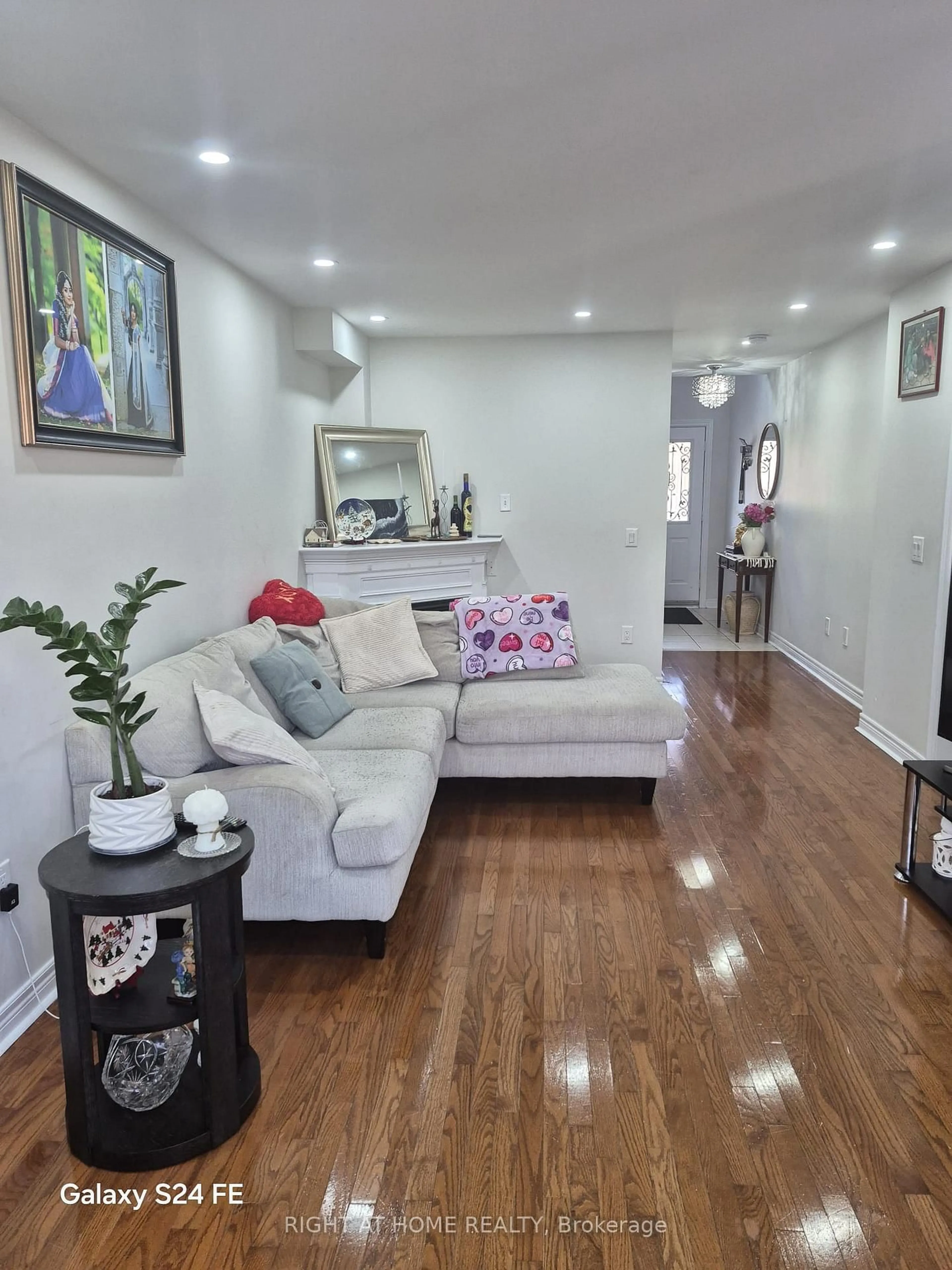 Living room with furniture, wood/laminate floor for 30 Trevino Cres, Brampton Ontario L6P 1L9