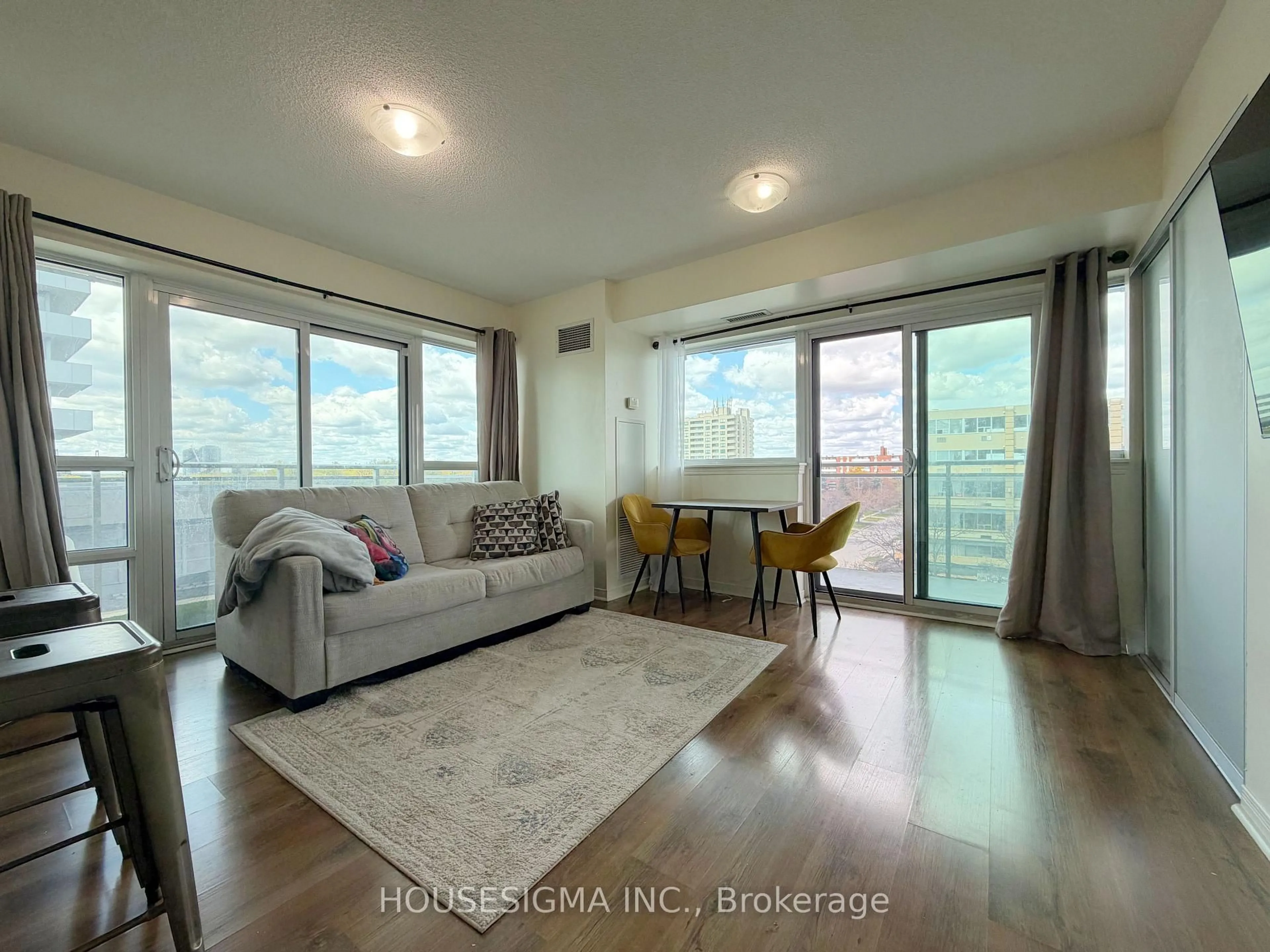 Living room with furniture, wood/laminate floor for 215 Queen St #509, Brampton Ontario L6W 0A9