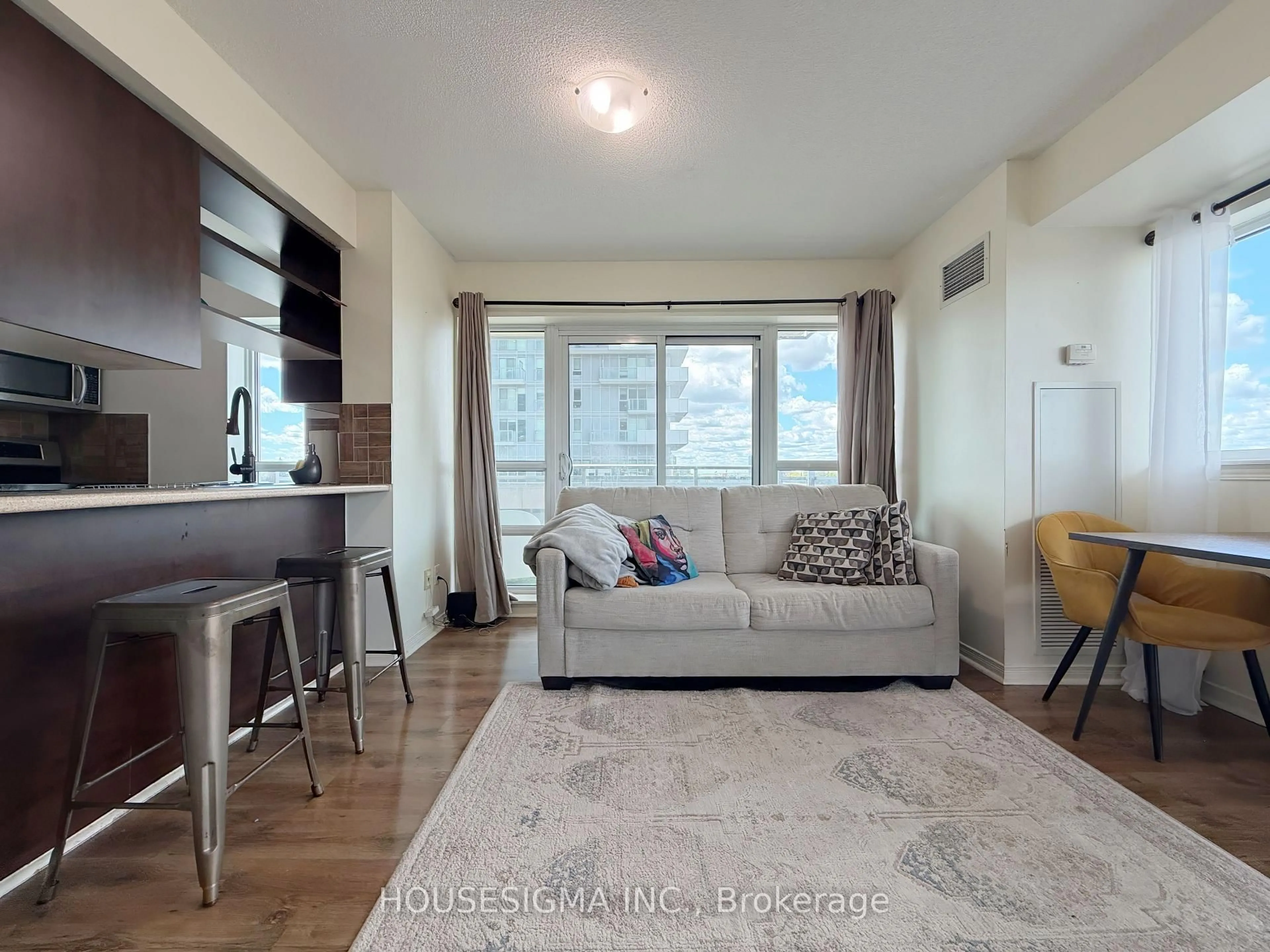Living room with furniture, wood/laminate floor for 215 Queen St #509, Brampton Ontario L6W 0A9