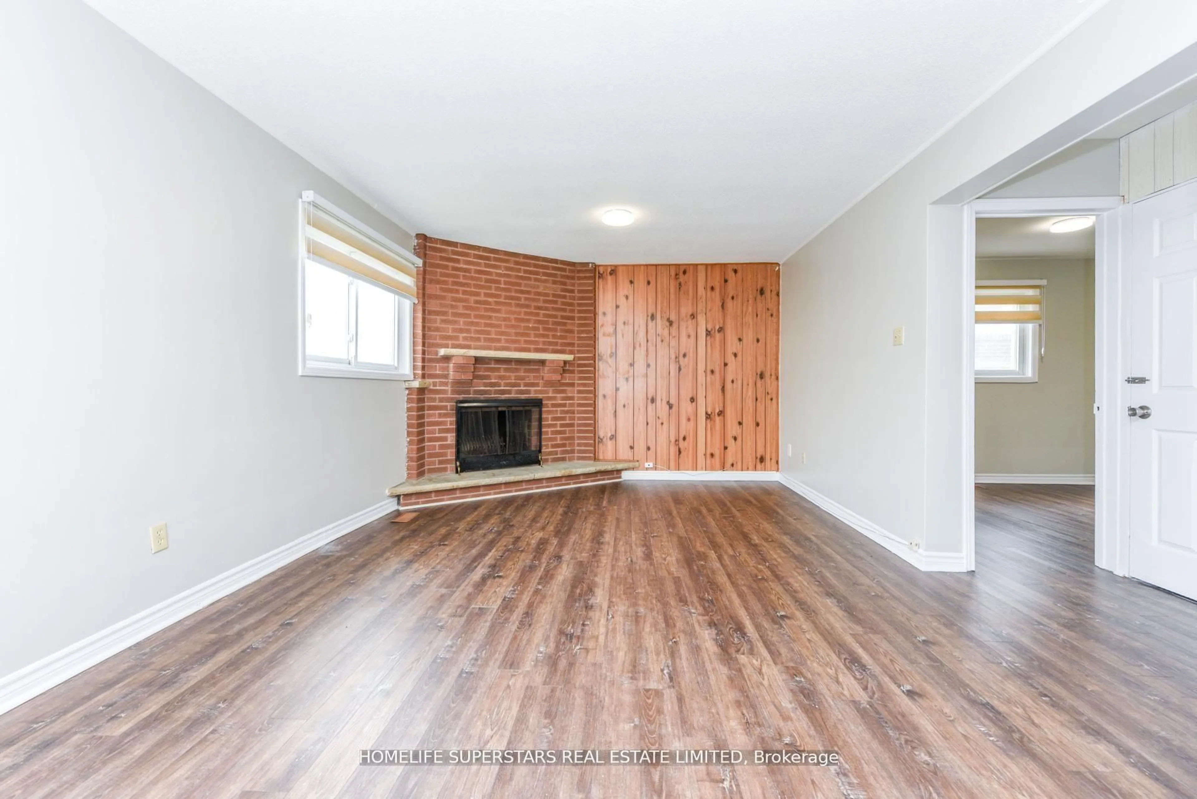 Living room with furniture, wood/laminate floor for 306 Royal Salisbury Way, Brampton Ontario L6V 3G5