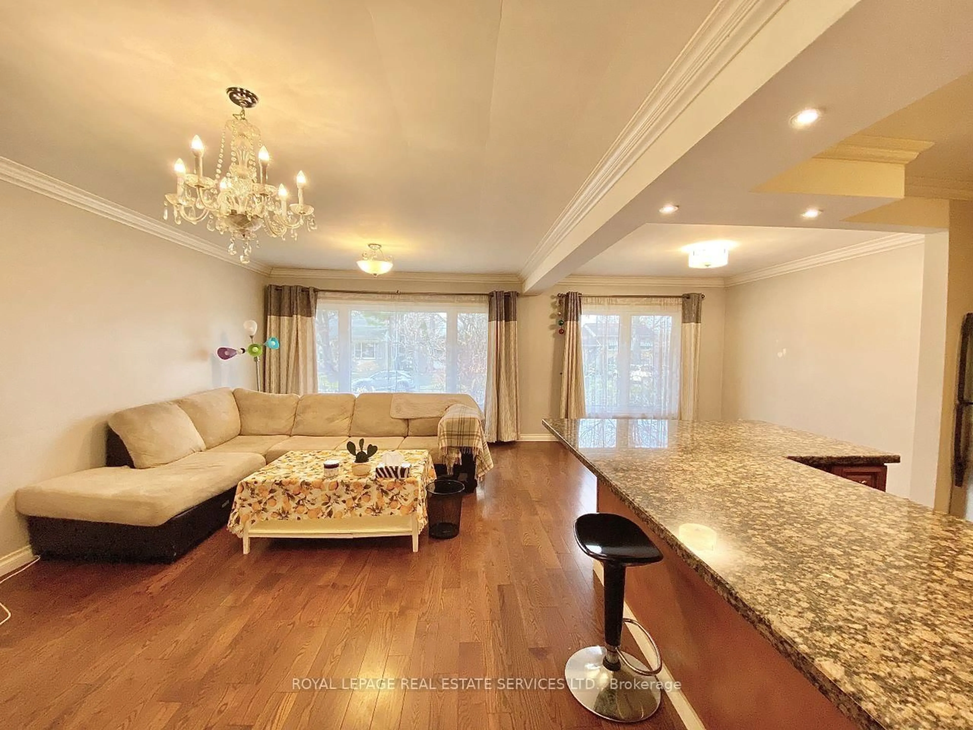 Living room with furniture, wood/laminate floor for 3009 O'Hagan Dr, Mississauga Ontario L5C 2C4