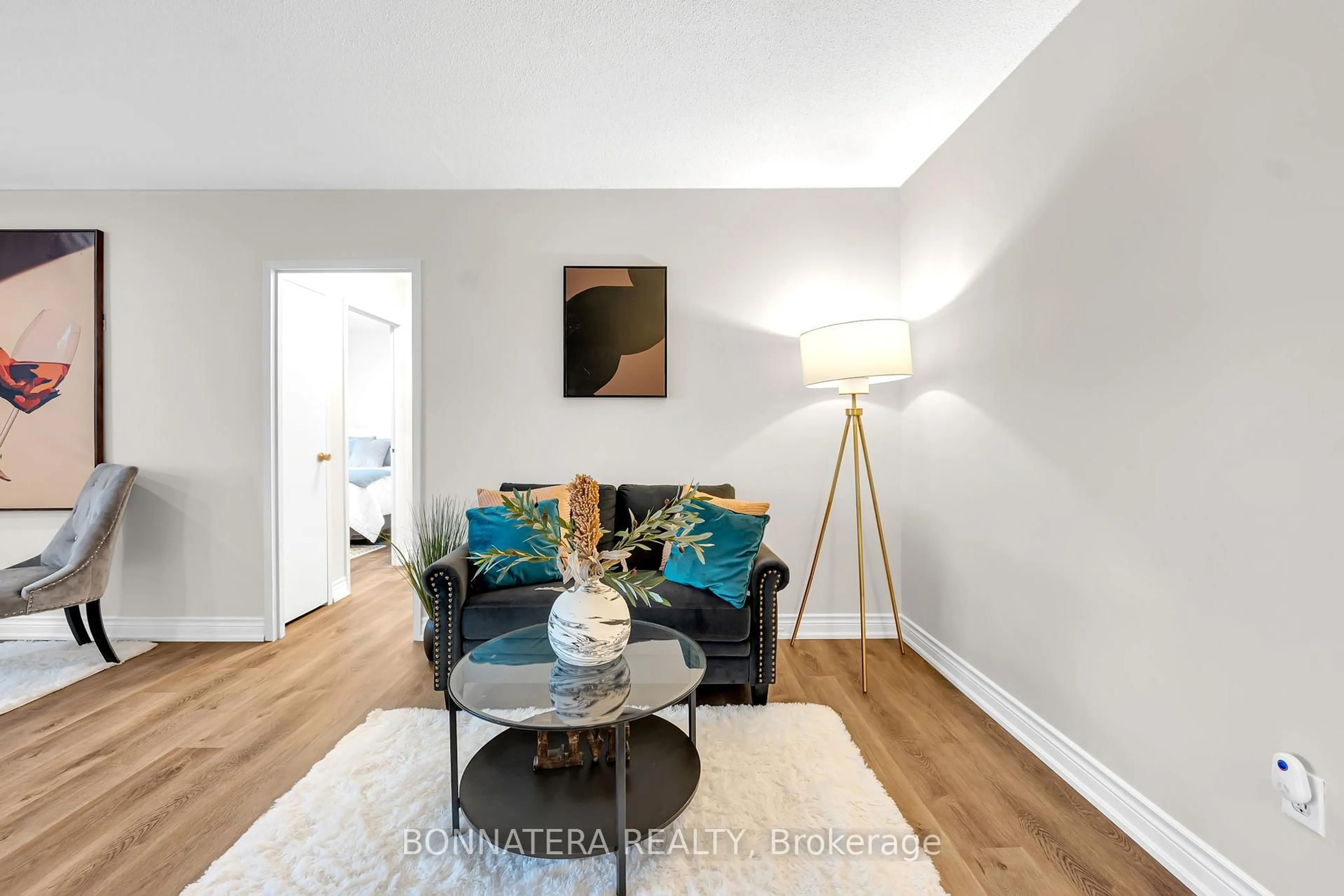 Living room with furniture, wood/laminate floor for 3065 Queen Frederica Dr #905, Mississauga Ontario L4Y 3A3