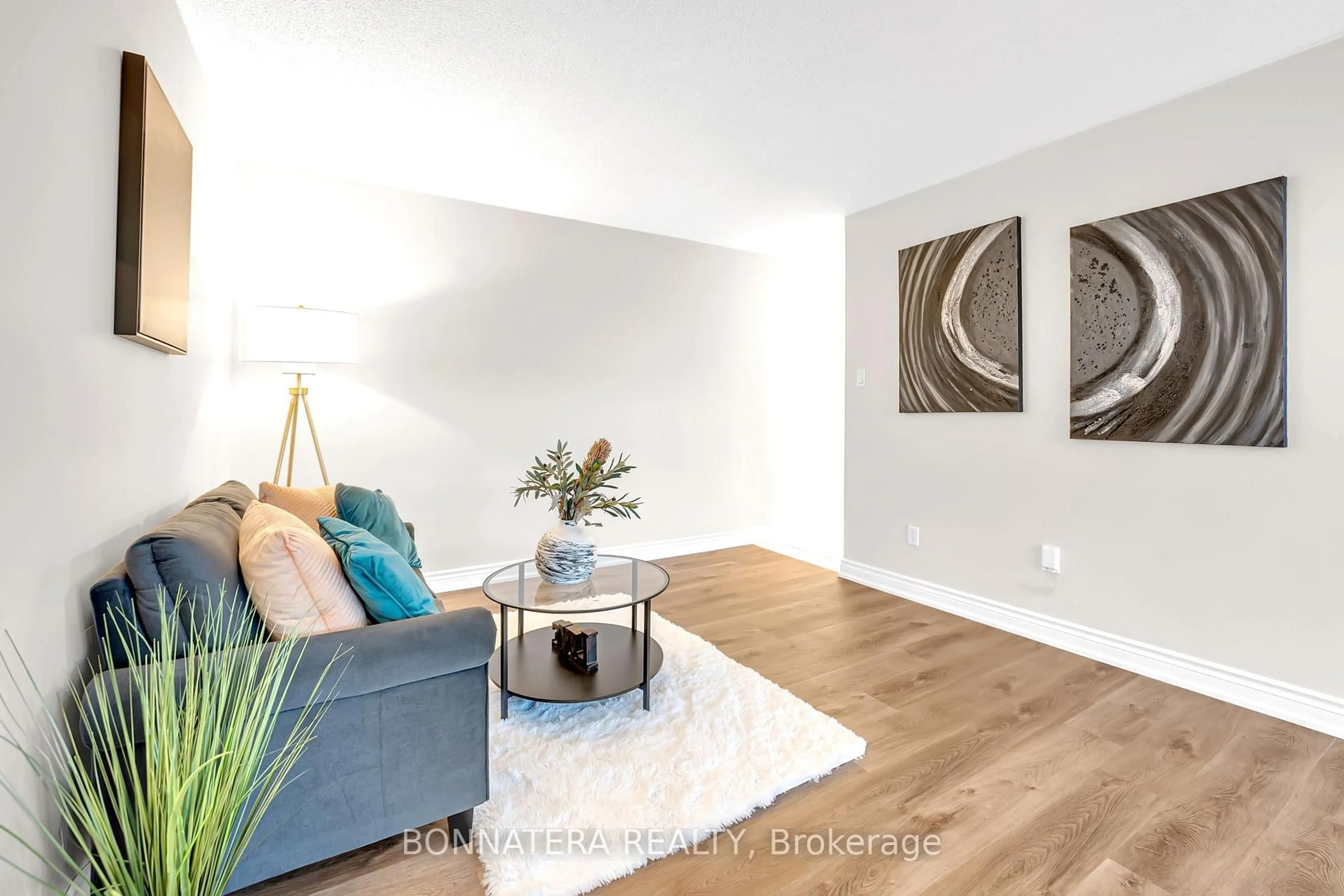 Living room with furniture, wood/laminate floor for 3065 Queen Frederica Dr #905, Mississauga Ontario L4Y 3A3