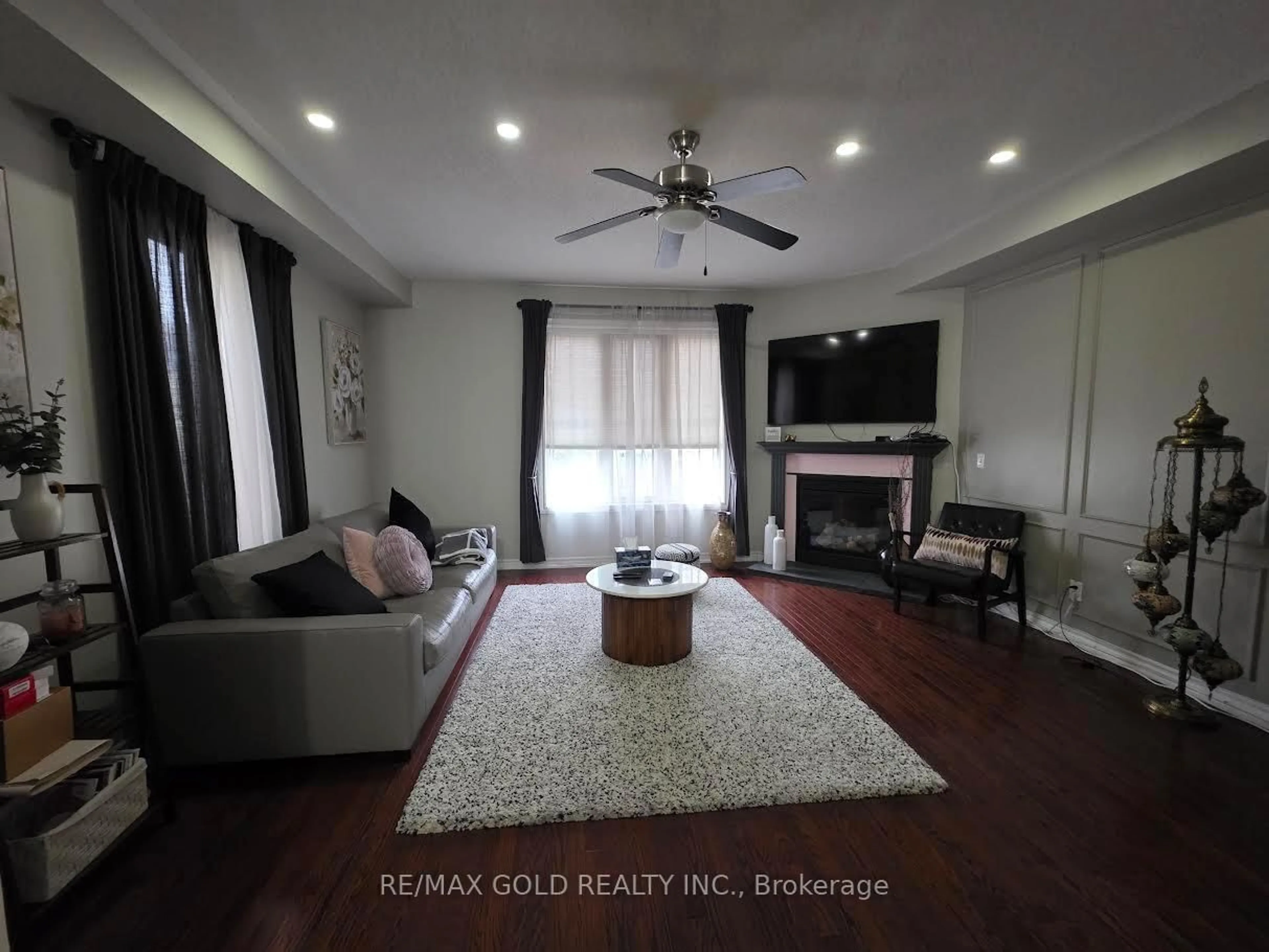 Living room with furniture, wood/laminate floor for 12 Cailiff St, Brampton Ontario L6Y 0P9