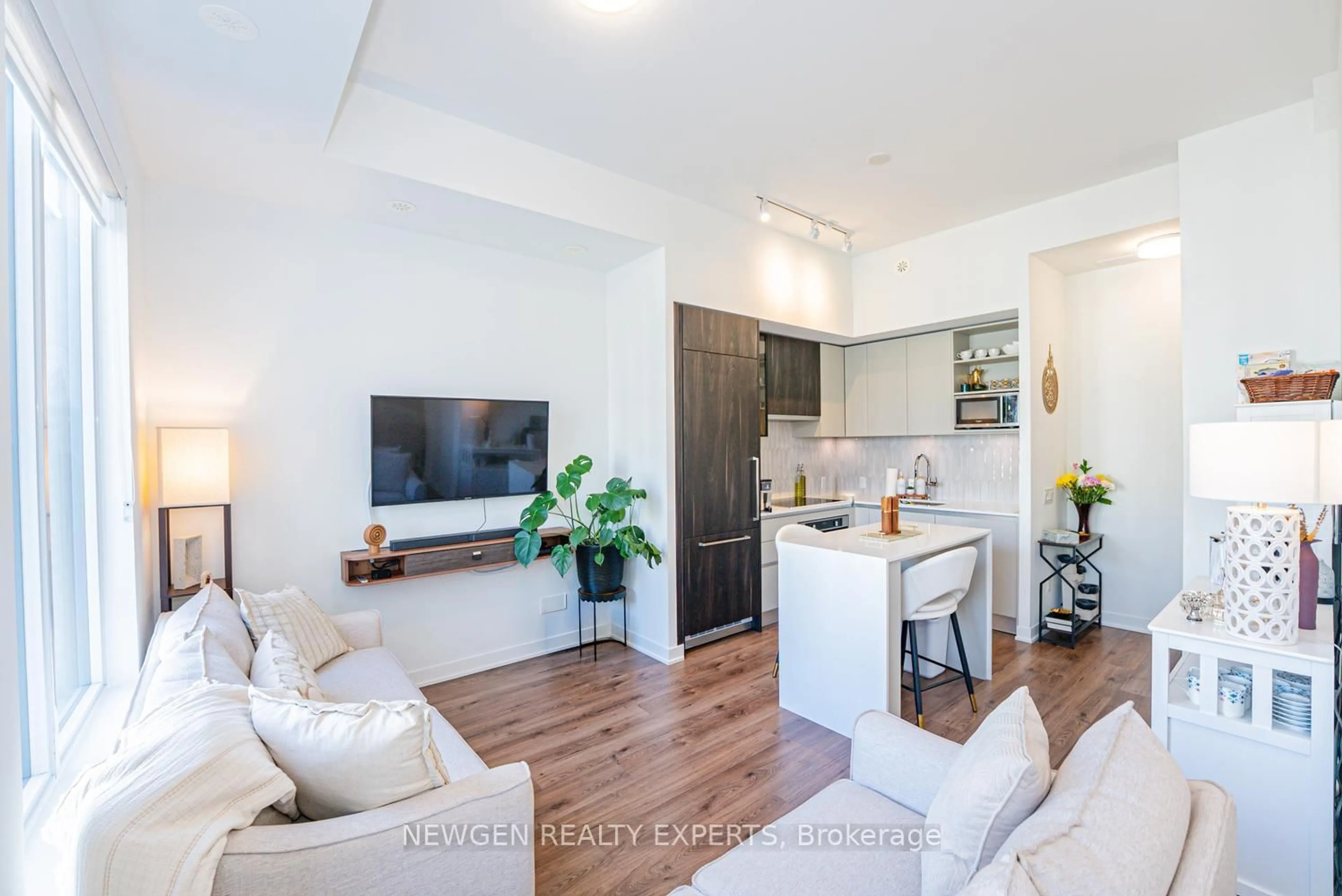 Living room with furniture, wood/laminate floor for 3020 Trailside Dr #129, Oakville Ontario L6M 4M2