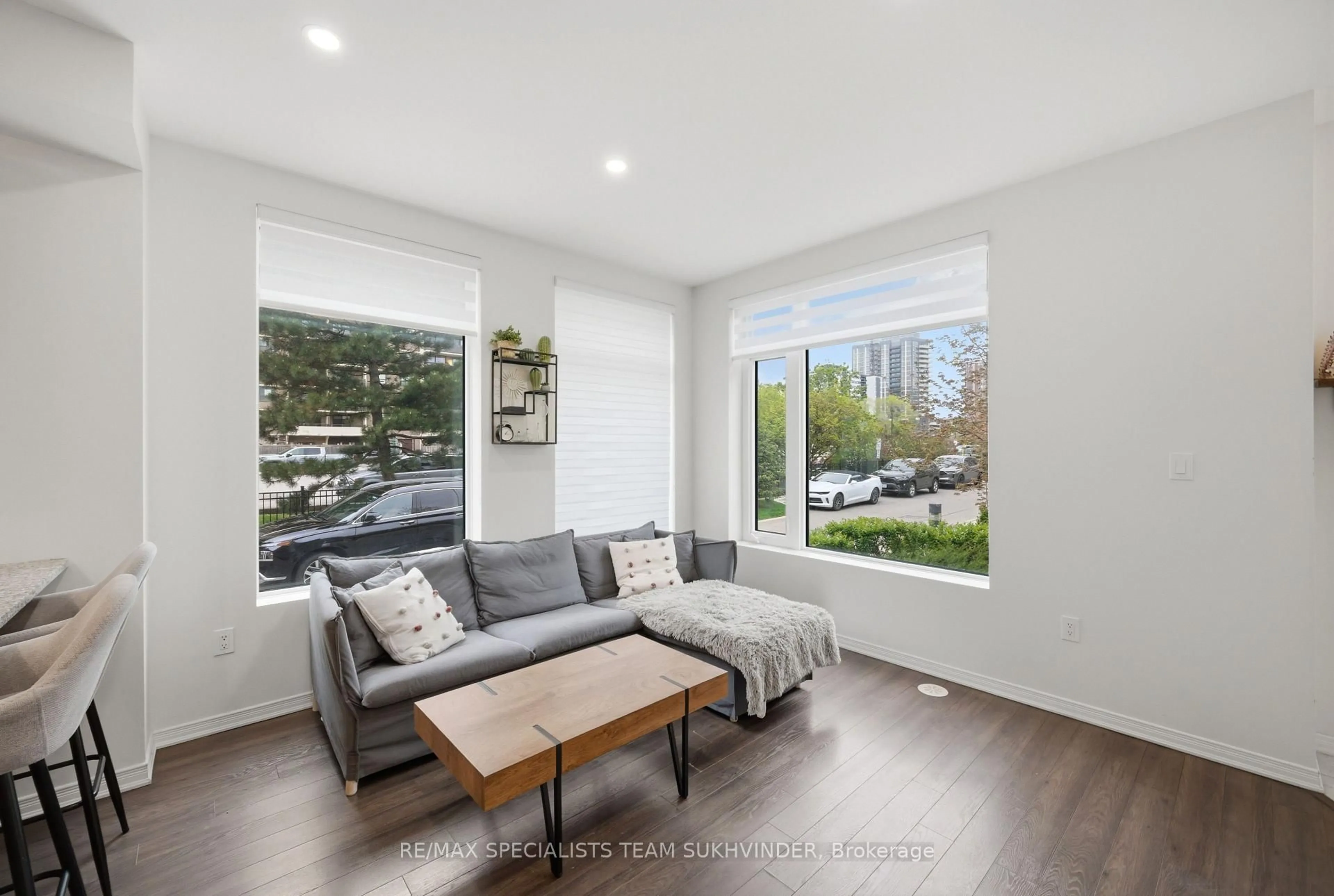 Living room with furniture, wood/laminate floor for 18 Applewood Lane #25, Toronto Ontario M9C 0C1