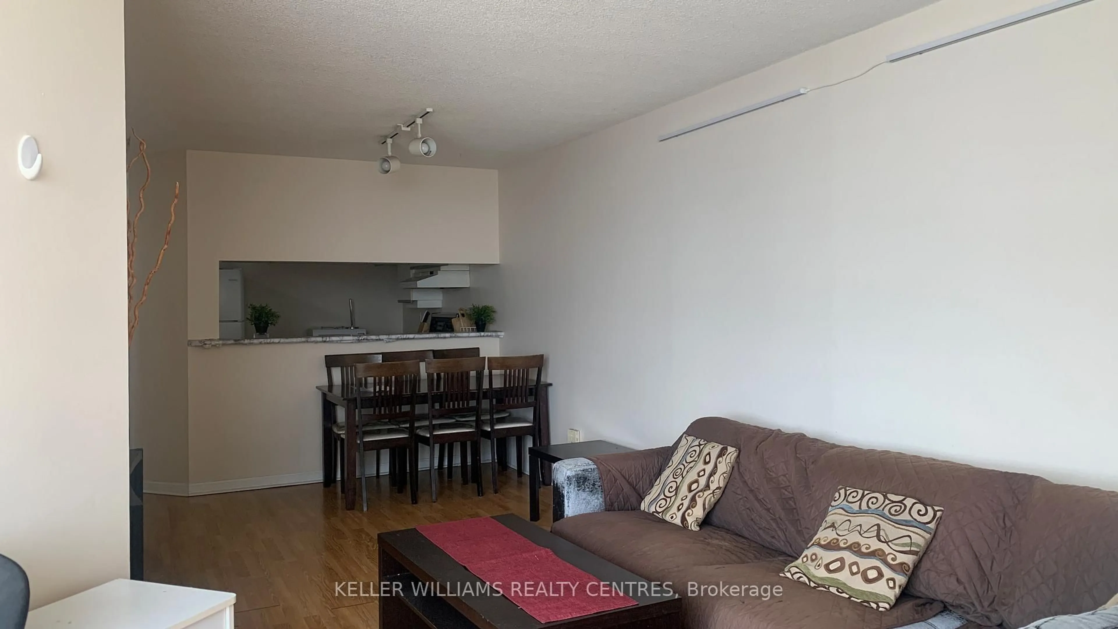 Living room with furniture, wood/laminate floor for 550 Webb Dr #1806, Mississauga Ontario L5B 3Y4