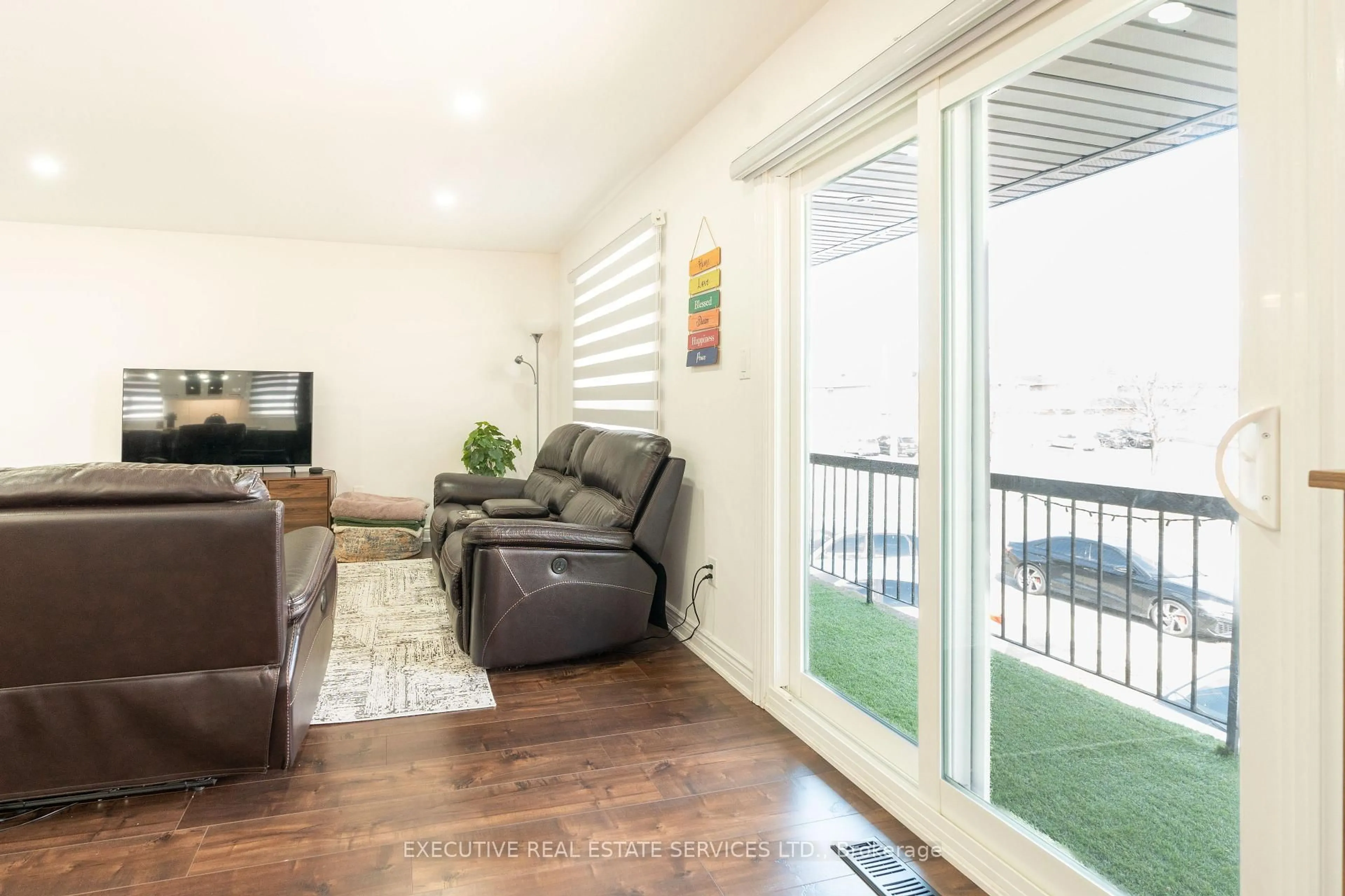 Living room with furniture, wood/laminate floor for 90 HINCHLEY WOOD Grve, Brampton Ontario L6V 3M3